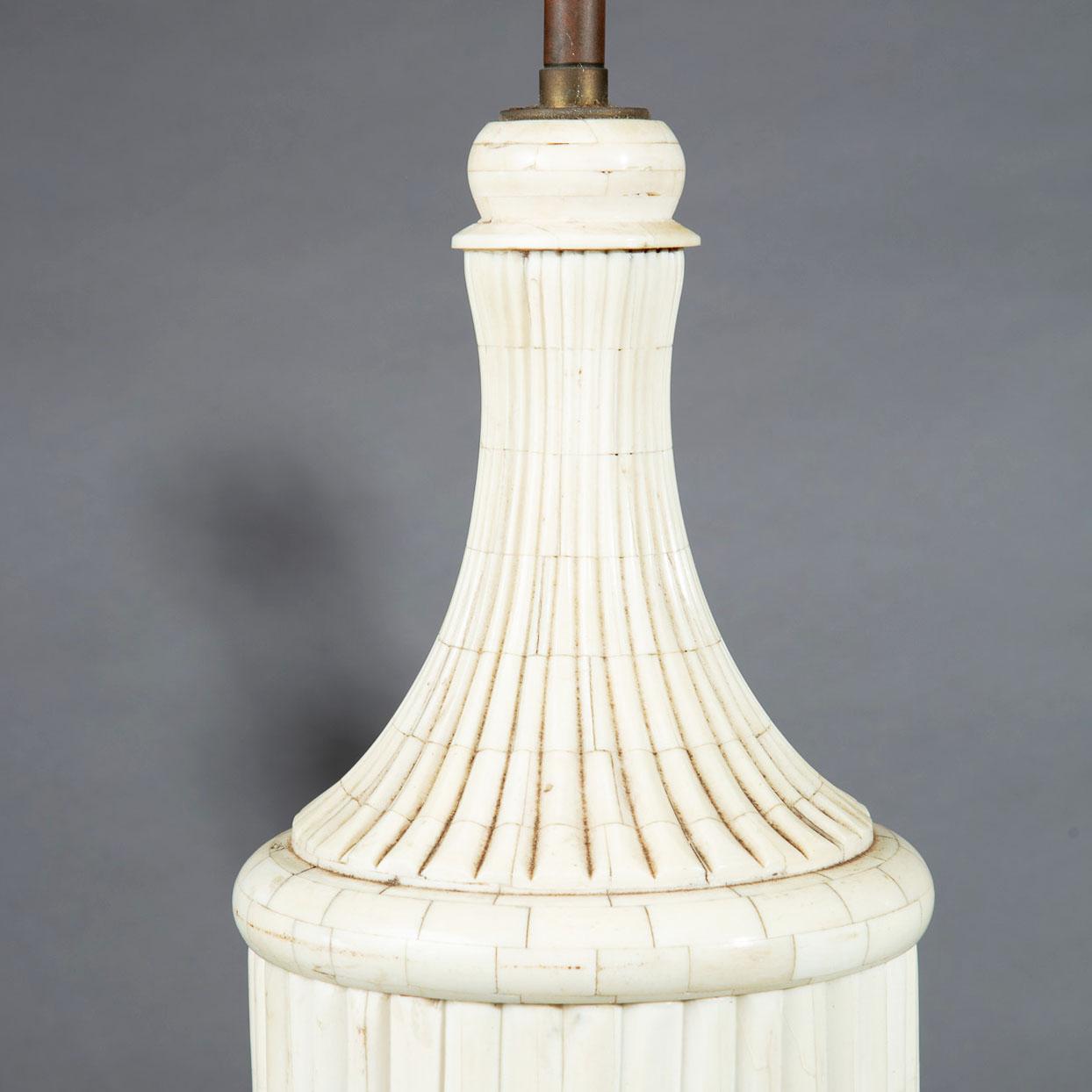 A tall pair of bone veneered baluster table lamps.
India, 20th century
Measures: Height 53cm to the top of the lamp column, and shade (not included)
Base 14cm square.

   