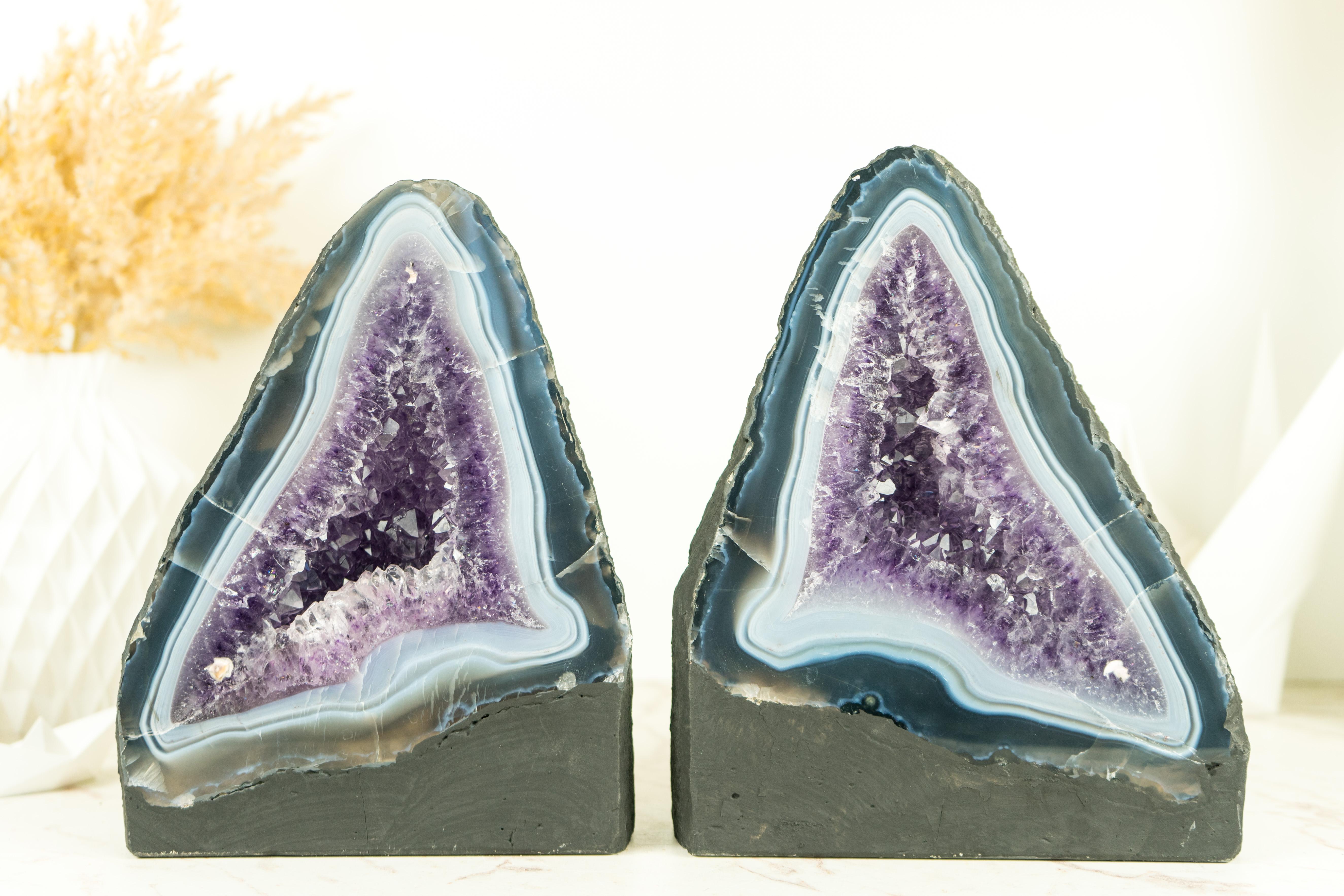Exquisite, this pair of Blue and White Lace Agate Cathedrals showcases stunning agate lines, book-matching patterns, and beautifully formed geodes. A pair of Geodes make a wonderful addition to any collection, bookshelf, or table decor.

The