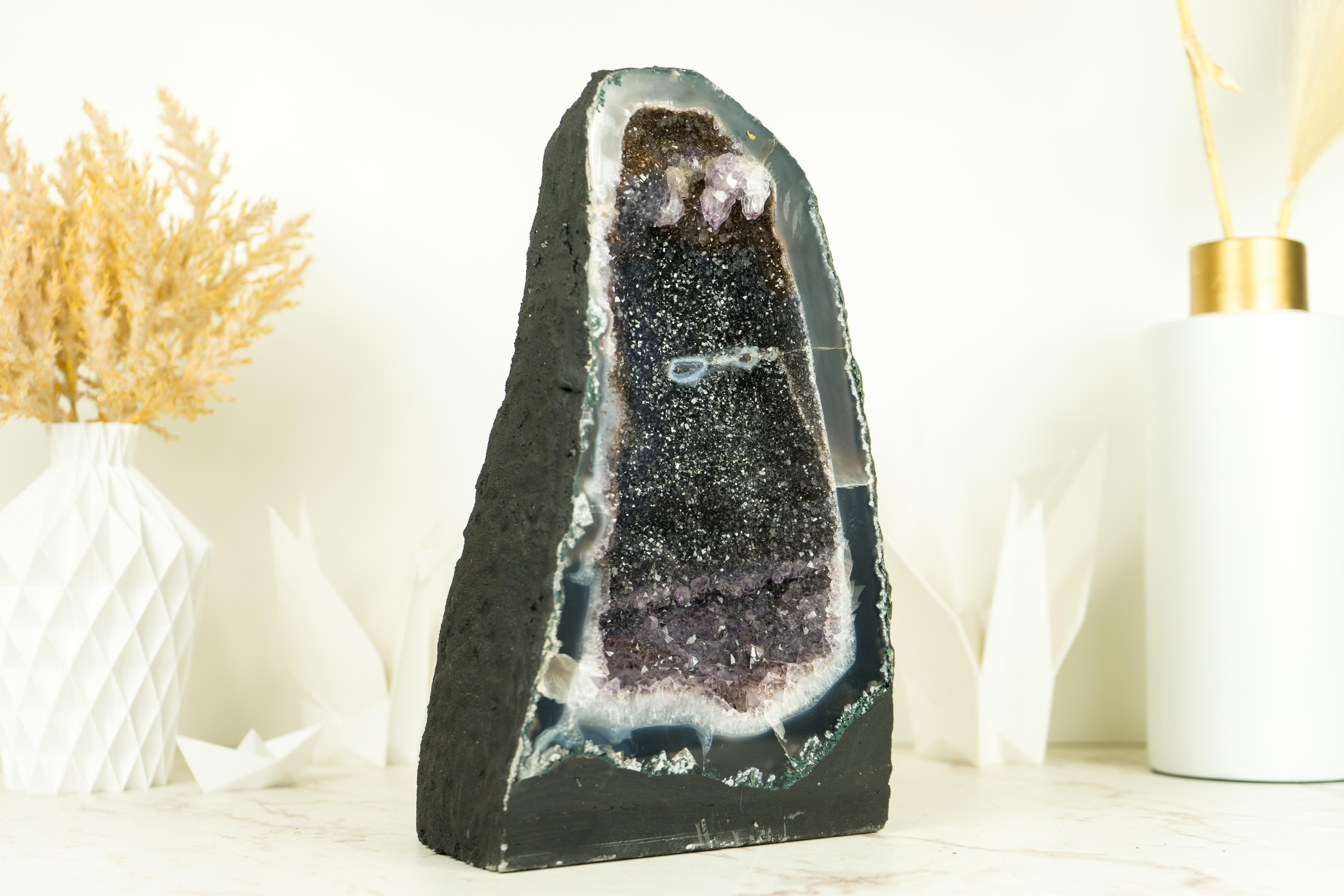 Elevate your space, decor, or collection with the captivating beauty of this pair of book-matching Amethyst Geode featuring mesmerizing Black Galaxy Druzy, a rare form of Amethyst that resembles a starry night sky captured within the crystal, and