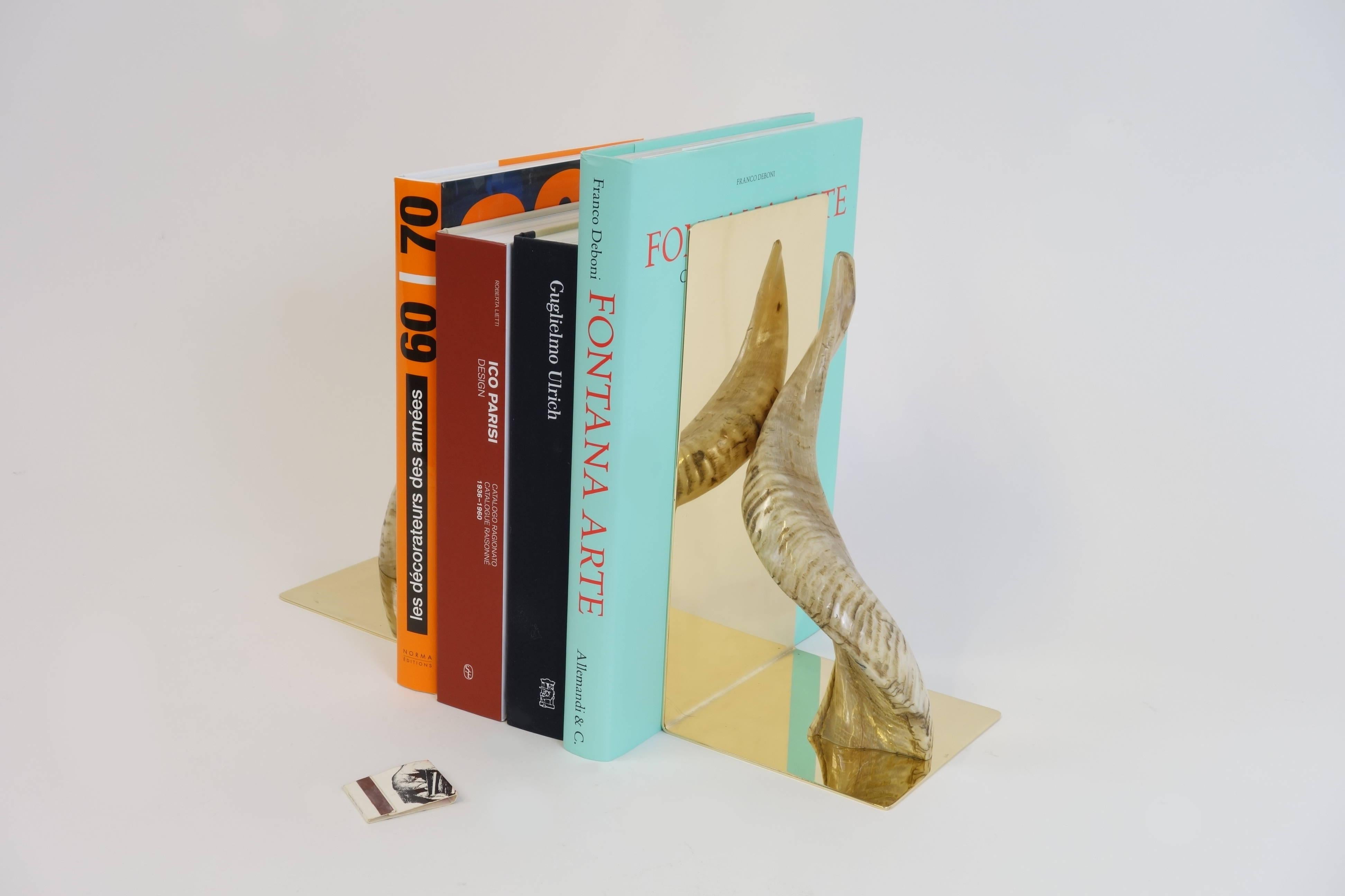 A pair of plus sized bookends created and manufactured by the Austrian architect and designer Carl Auböck. These outstanding objects made of solid brass will provide understated luxury on each bookshelf. The curves as well as their mild hue offer a