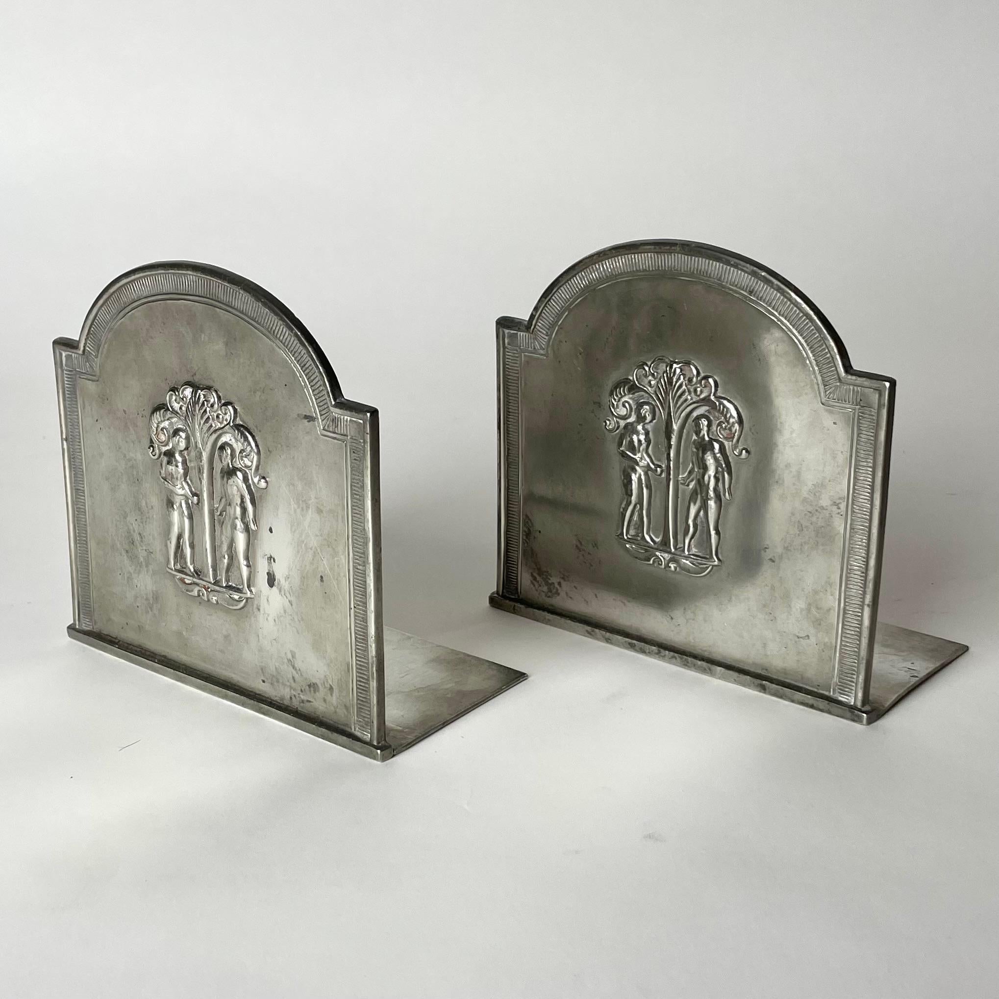 A beautiful Pair of Bookends in Pewter with decoration of Adam and Eve. Designed in 1930 by the famous designer Just Andersen (1884-1943) from Denmark and manufactured by the Swedish company GAB (Guldsmedsaktiebolaget).

Wear consistent with age and