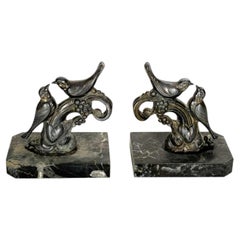 Pair of bookends with brass birds and marble bases, 19th century
