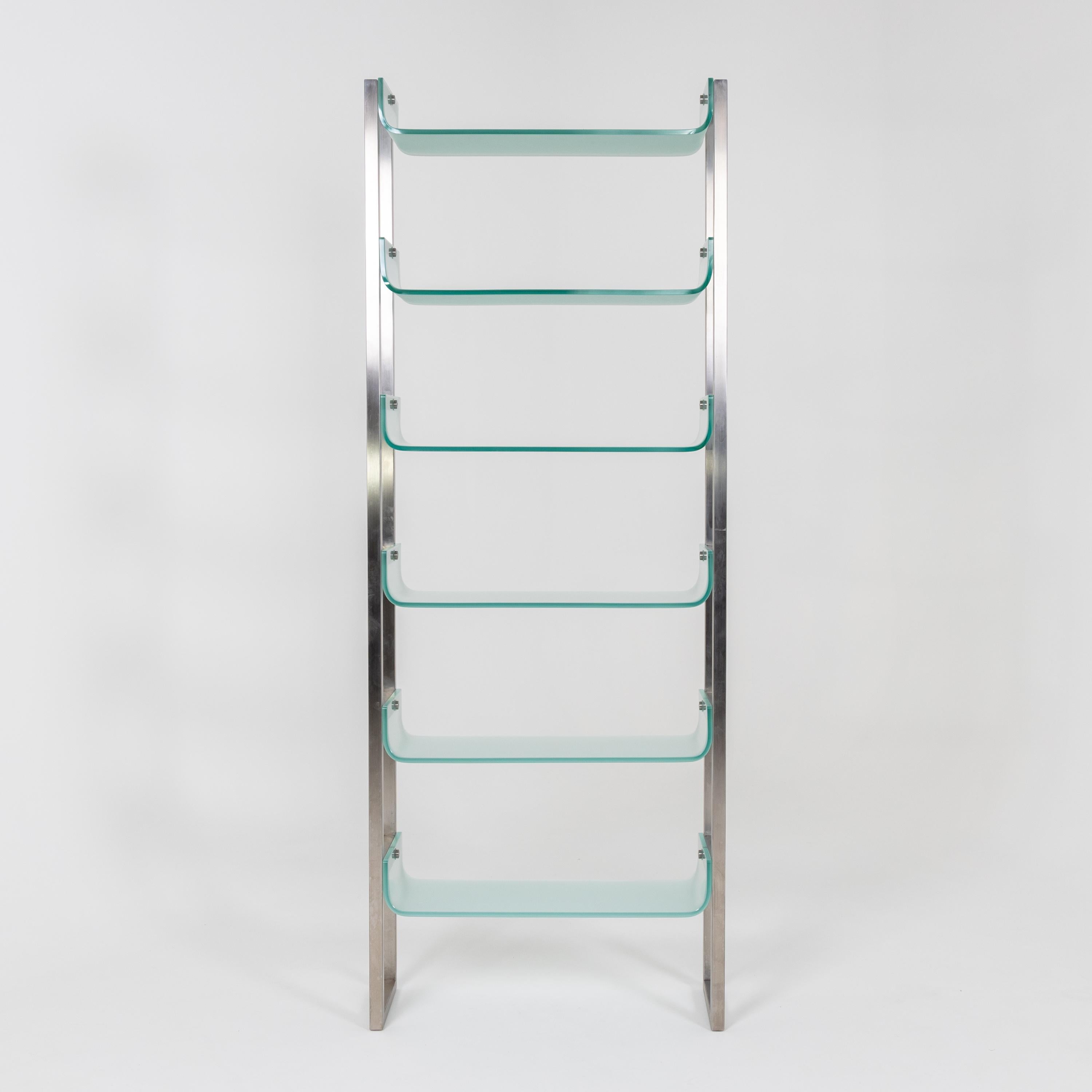Pair of steel bookcases with dish-shaped shelves of light blue glass.