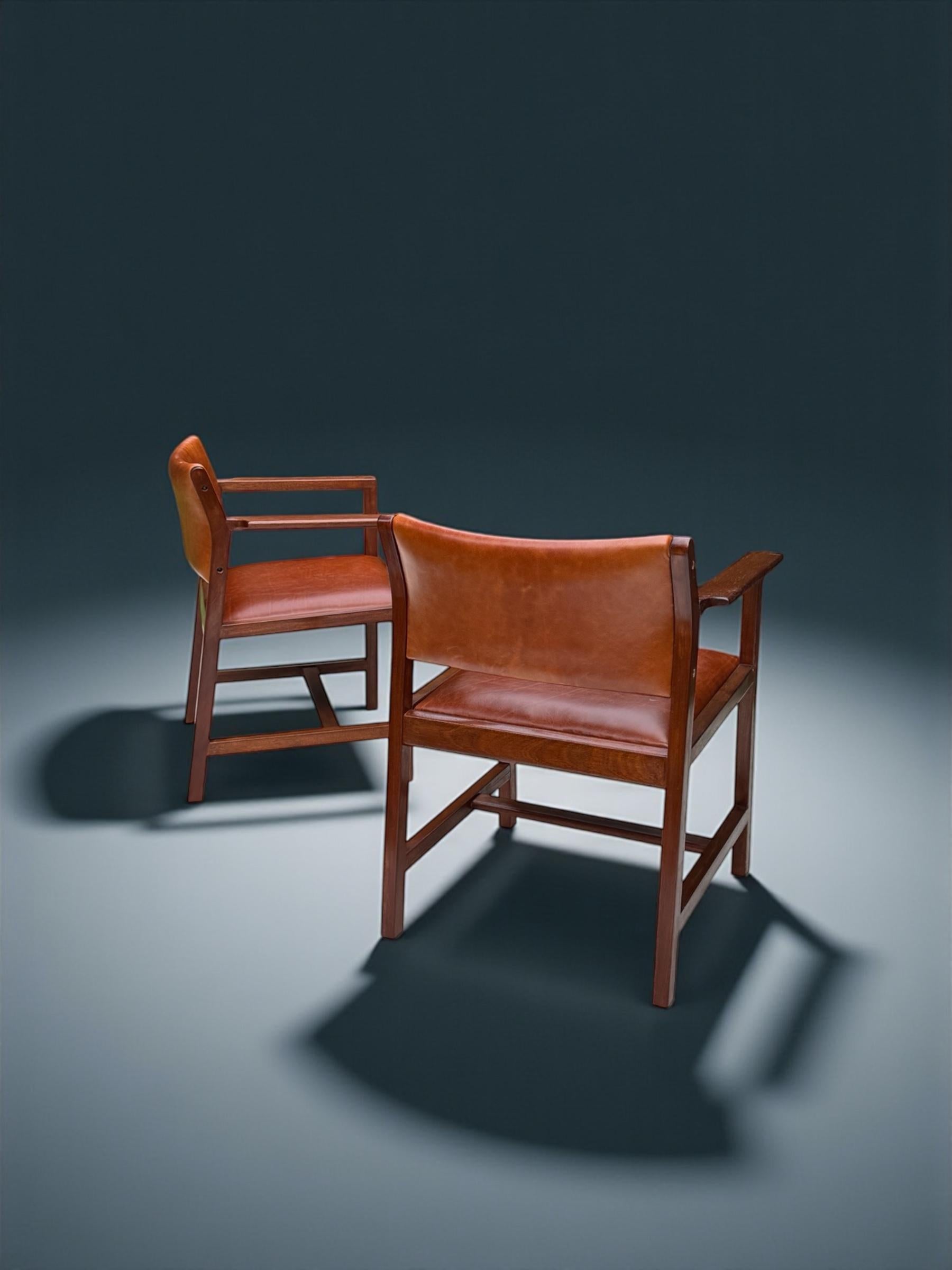 A stunning pair of characterful armchairs by master Danish designer, Borge Mogensen for Soborg Mobelfabrik 1960's. The rich colour teakwood is perfectly complimented by the Cognac colour tanned smooth texture leather is truly an irresistible