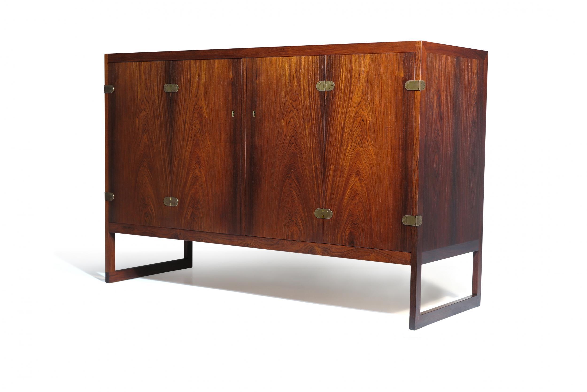 Pair of Scandinavian Rosewood Cabinets designed by Borge Mogensen for P. Lauritsen & Son Denmark, Model BM 57. The cabinets are crafted of dark Brazilian rosewood with brass hardware, oak interior with silverware drawers and adjustable shelves,