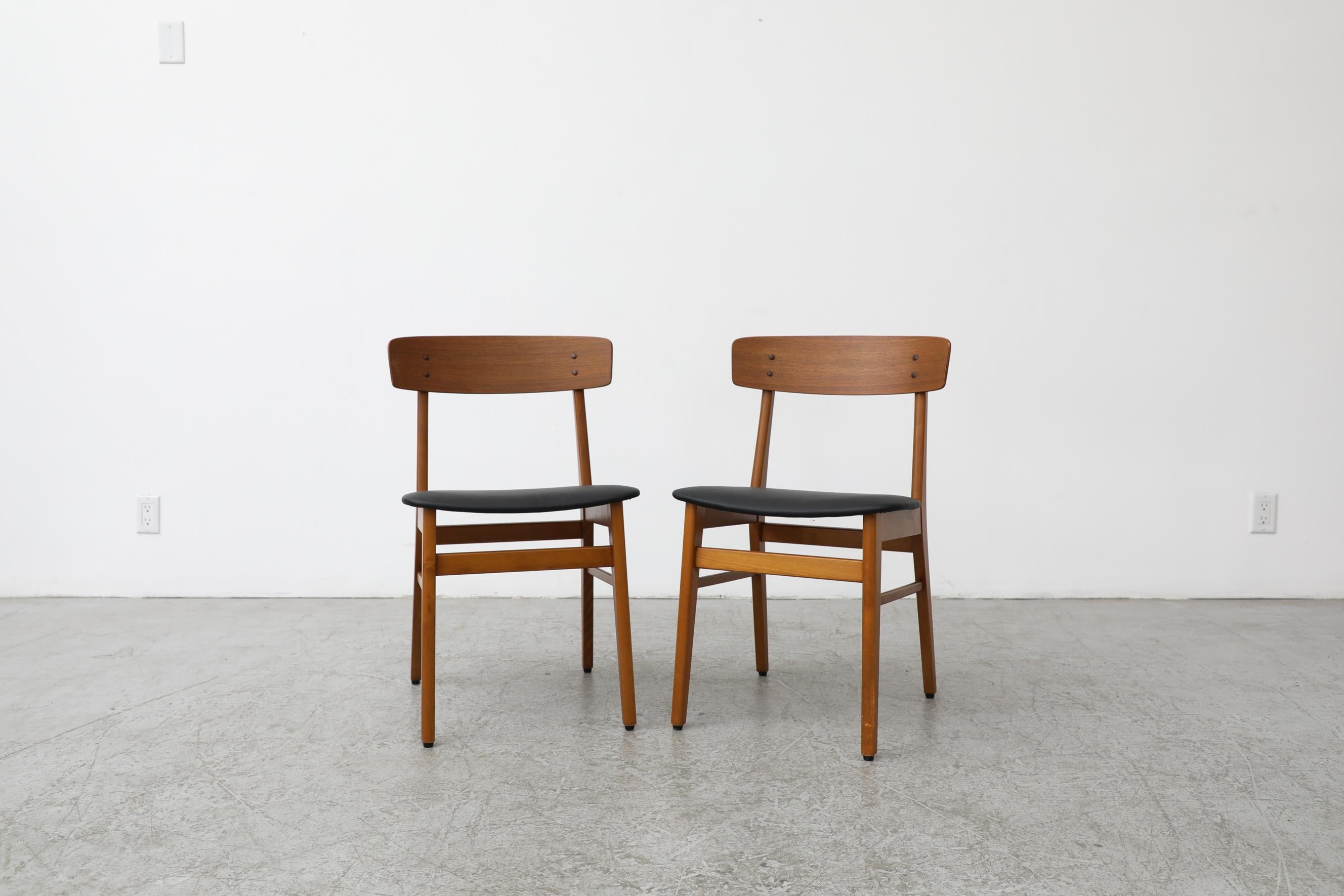 Pair of Borge Mogensen style chairs by Farstrup with black skai seats. In the 1950s and 60s, Farstrup's production of chairs expanded significantly making it one of the more well known and defining Danish brands of the era. The company has since