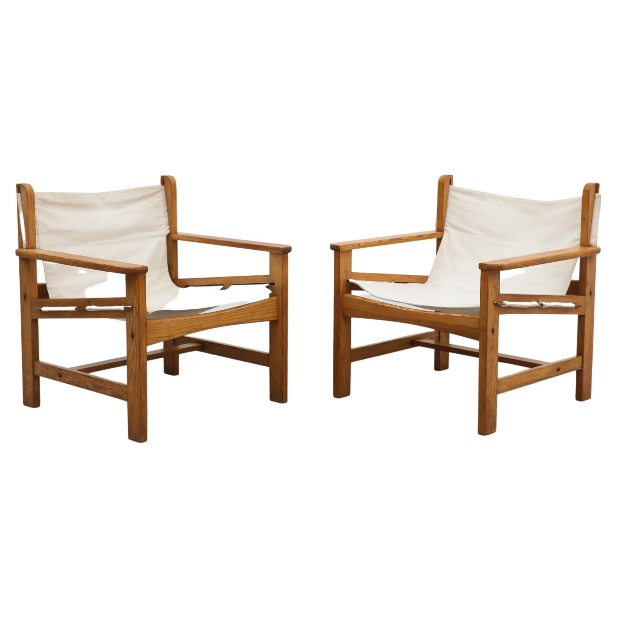 Pair of mid century Mogensen inspired safari chairs with pine frames and canvas sling seats. In original condition with visible wear consistent with their age and use. Set price.