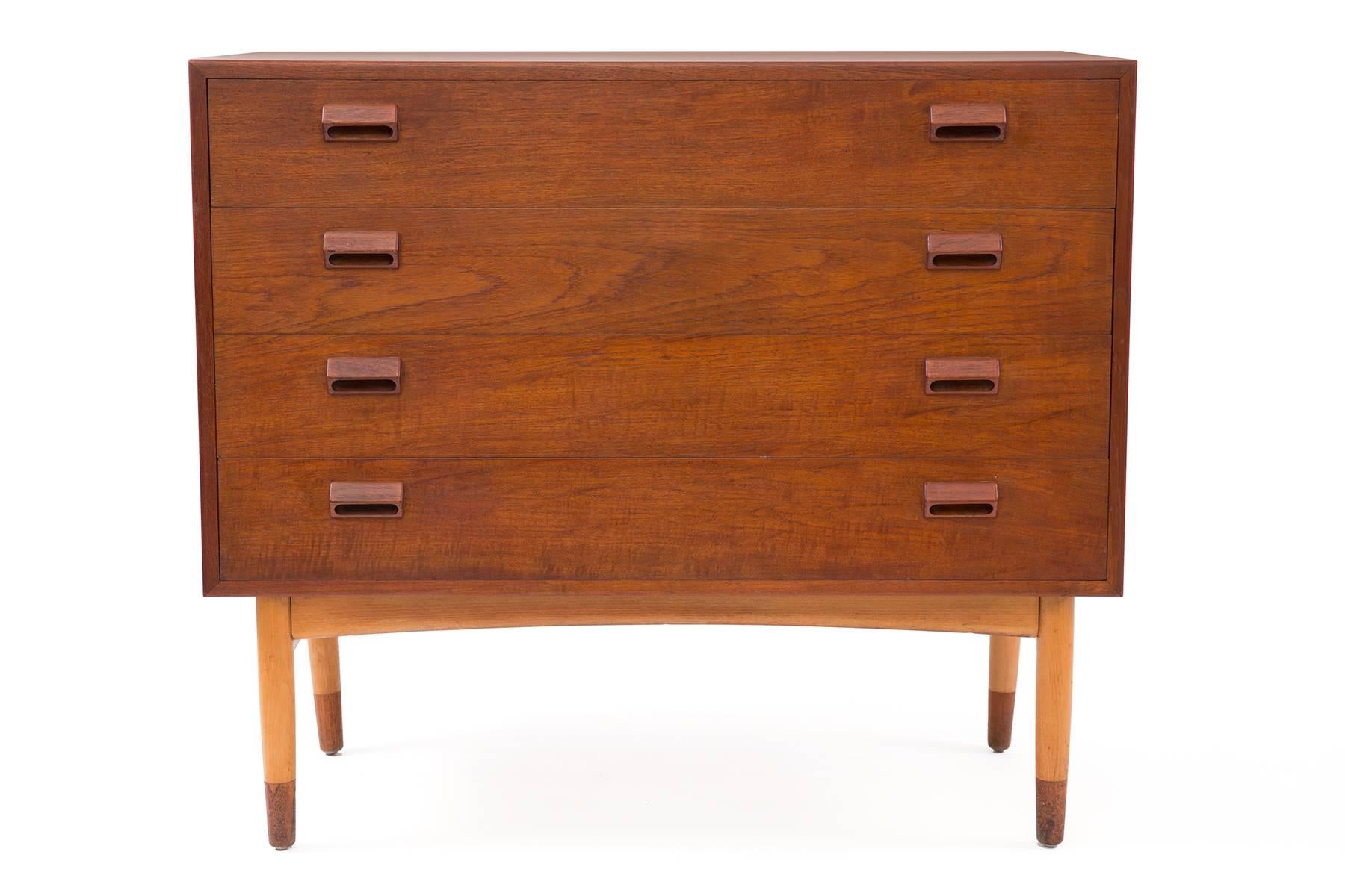 Pair of Borge Mogensen teak and beech chests, circa late 1950s. These all original examples each have four drawers with inset teak handles, solid teak and beech legs and beautifully grained teak cases. Price listed is for the pair of chests.
  