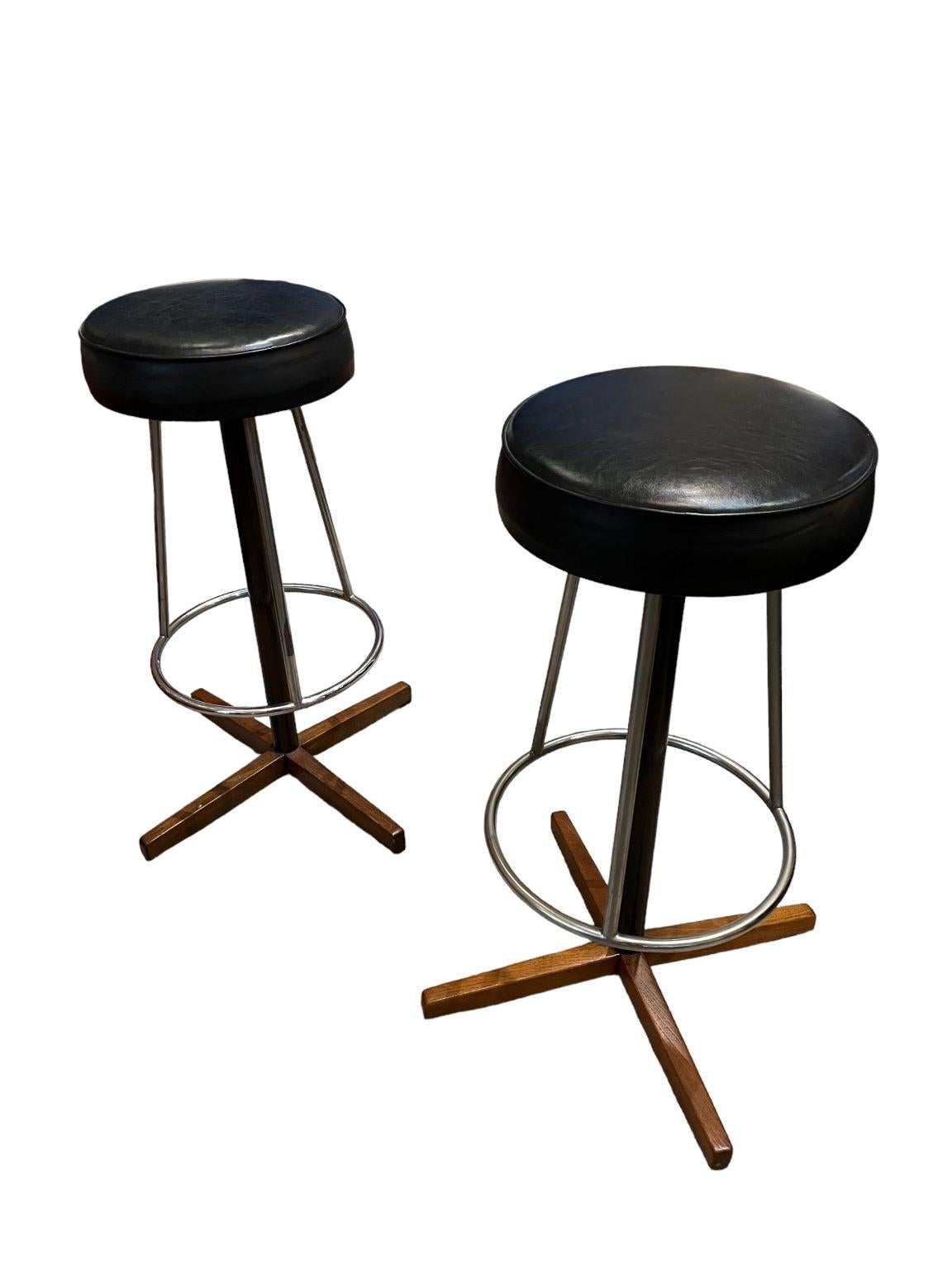 Borje Johanson Teak & Chrome and black bar stools for Johanson Design. Beautiful, rare pair of bar stools with an incredible and simple design. Marked on both stools. One stool shows a repair to the vinyl as shown. Reupholstery is available for