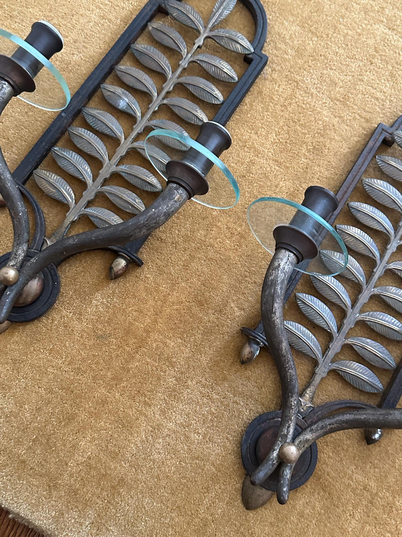 Pair of bronze botanical sconces with glass detailing. Requires electrification and wiring to meet US standards. 