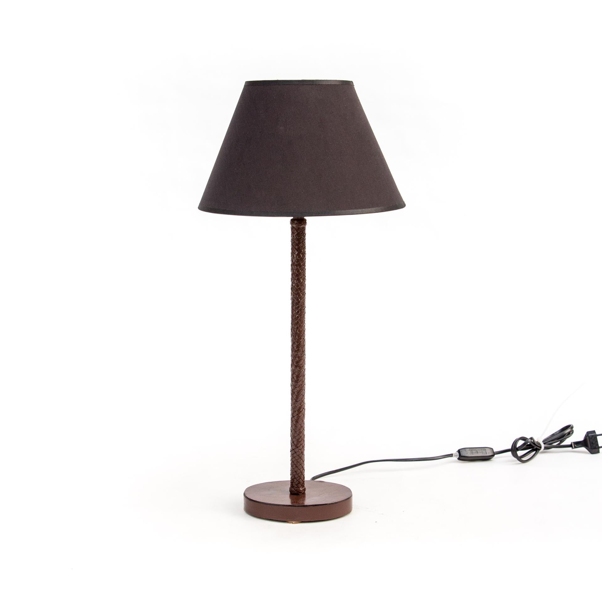 A pair of Bottega Veneta lamps with leather braid. Made in precise and time-consuming technique, which makes this brand recognizable.

The lamps have a reduced, Minimalist form. Straight, thin stems are placed on oval, small and low bases. Black