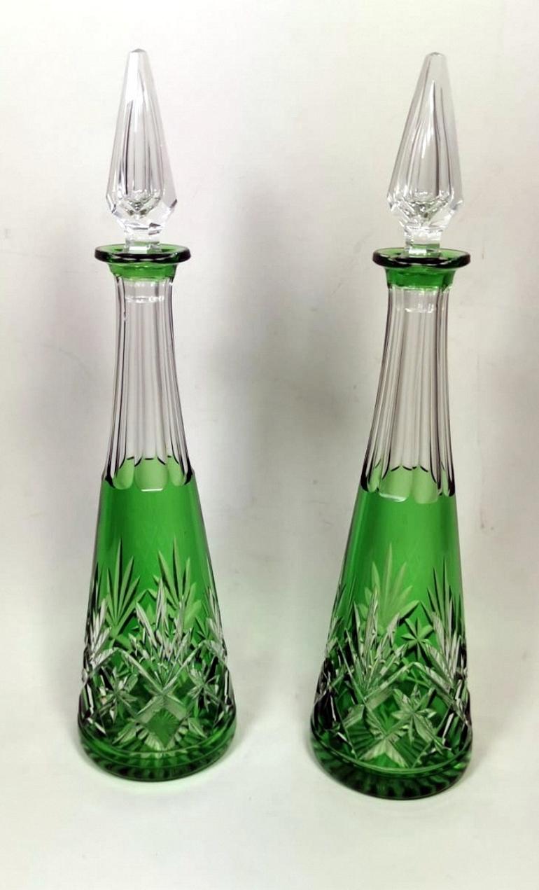 Pair of bottles in green crystal, cut and ground by hand; for their execution crystal with a lead percentage of 30% has been used; the high lead content, instead of calcium, present in the common glass, gives the crystal a high refractive index;