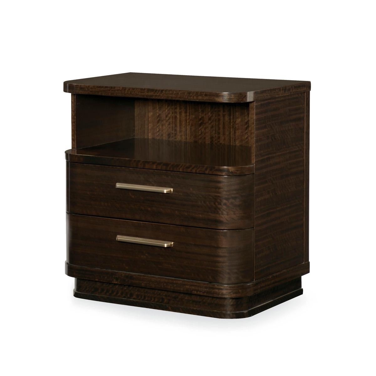 Dark and handsome, this modern nightstand hints at throw-back designs from the 1940s. Sporting rounded corners, a solid recessed plinth base and retro-era metal hardware, this nightstand has an open compartment with wire access through the shelf and