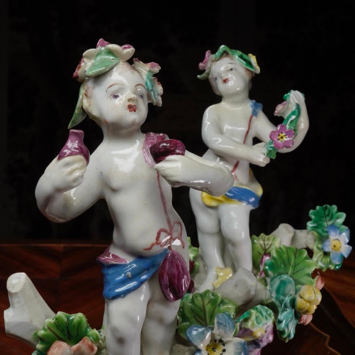 Rococo Pair of Bow Cherub Figures on Plinths, Decked with Flowers, circa 1765 For Sale