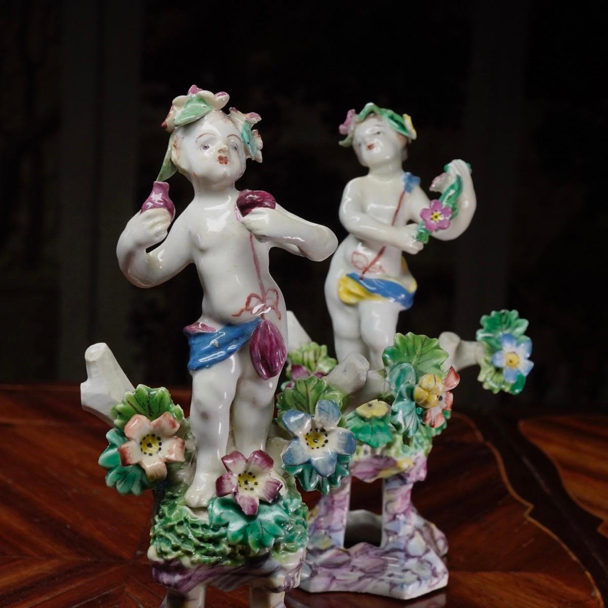 English Pair of Bow Cherub Figures on Plinths, Decked with Flowers, circa 1765 For Sale