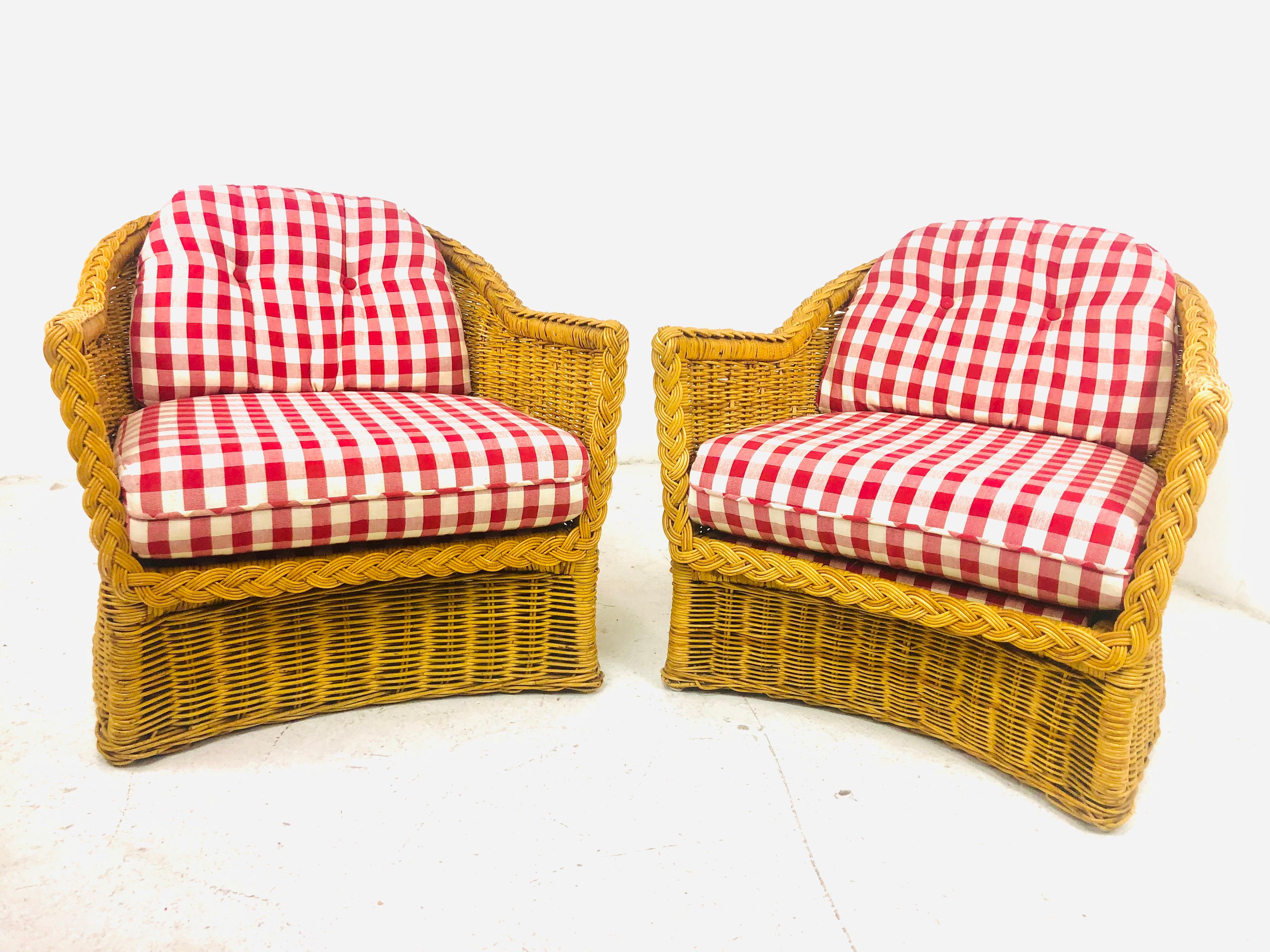 Pair of Wicker Works braided rattan club chairs with upholstered seat and back cushions. Signature braided rattan edging. Some very minor imperfections (pictured) but overall great condition - no breaks or damage to rattan.

 