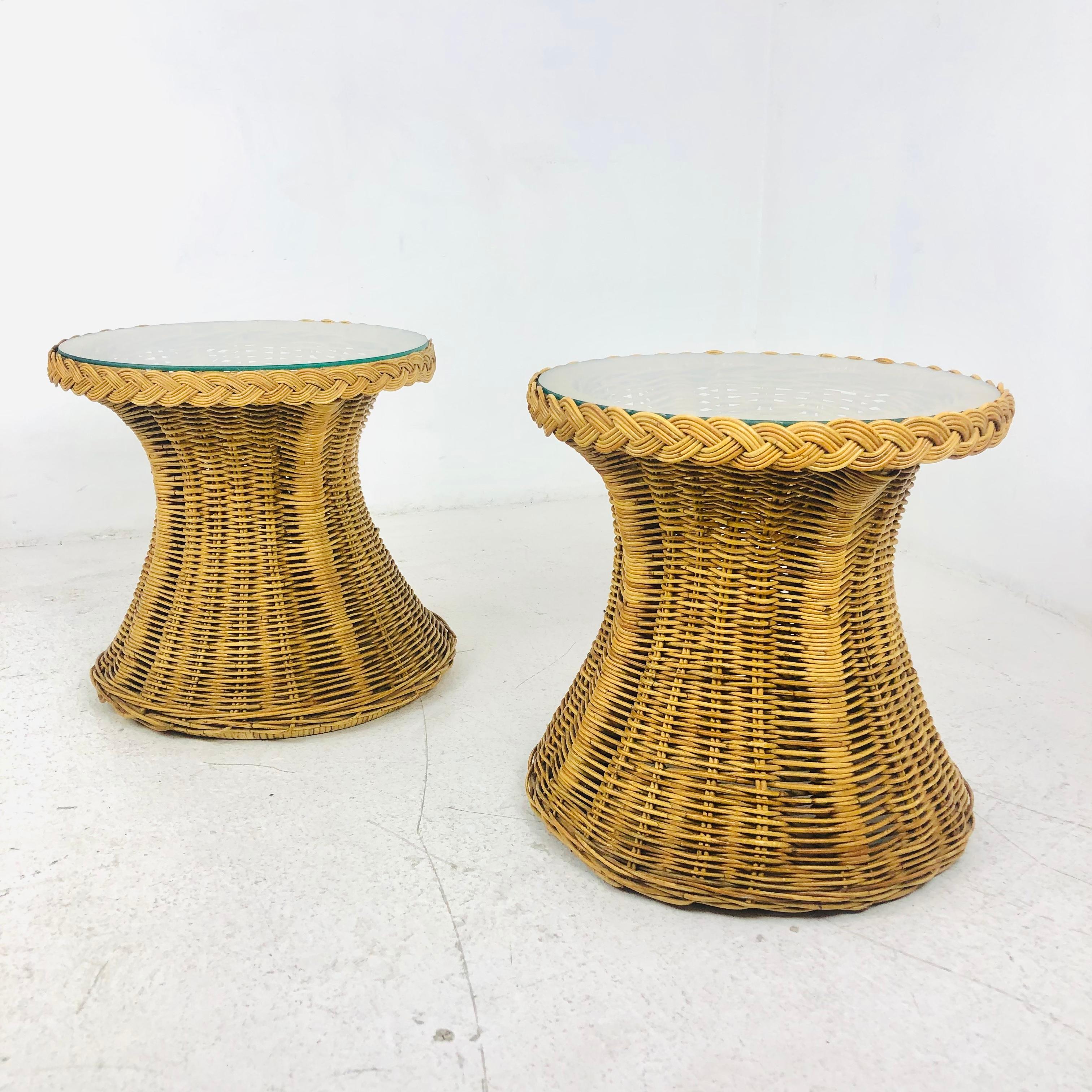 Pair of round vintage rattan side tables with glass tops. Set is in excellent condition. Base is 19