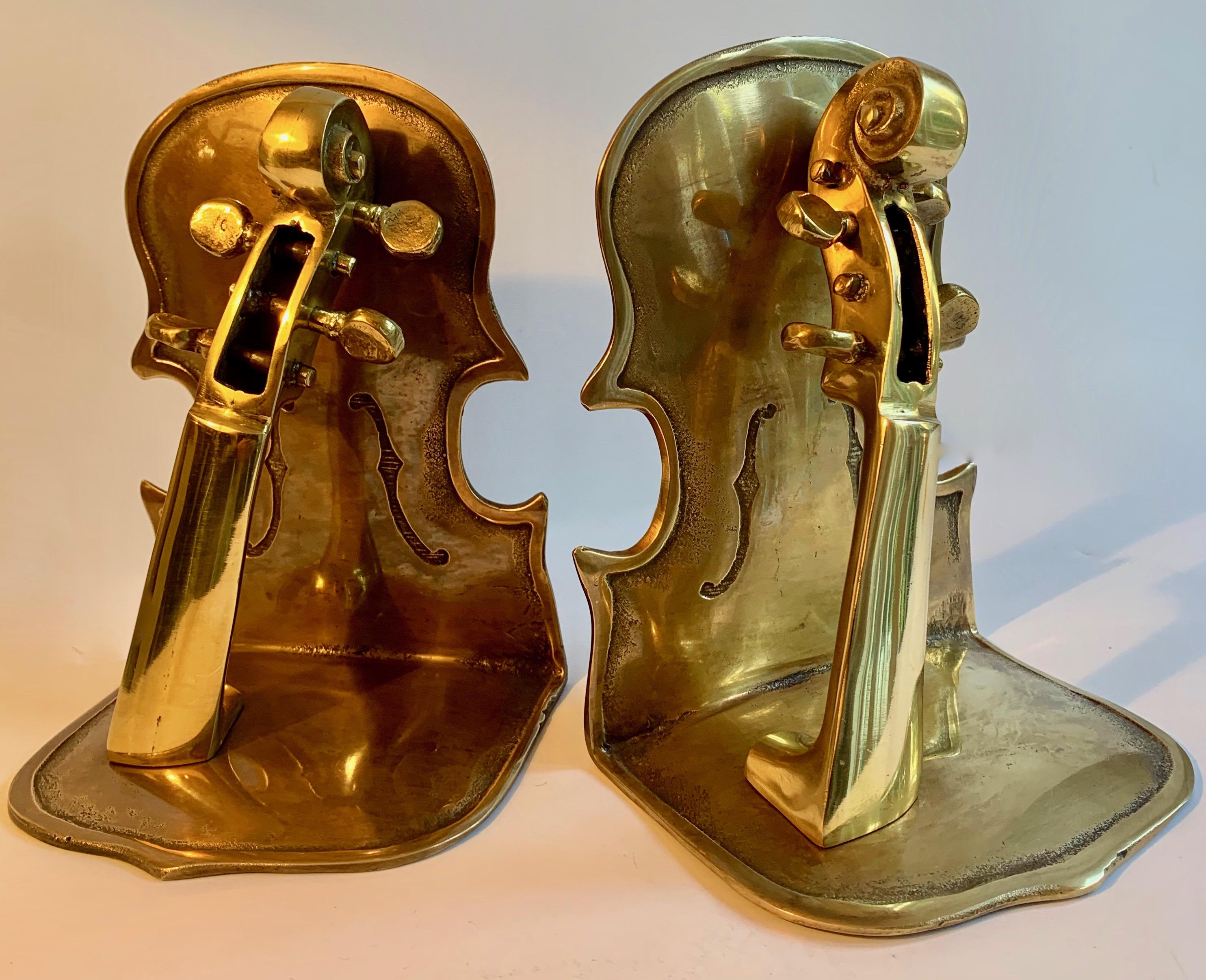 Pair of solid brass guitar bookends, or a guitar shaped instrument! Three dimensional and solid, the pair are the perfect companion to the music enthusiast or books on the subject.