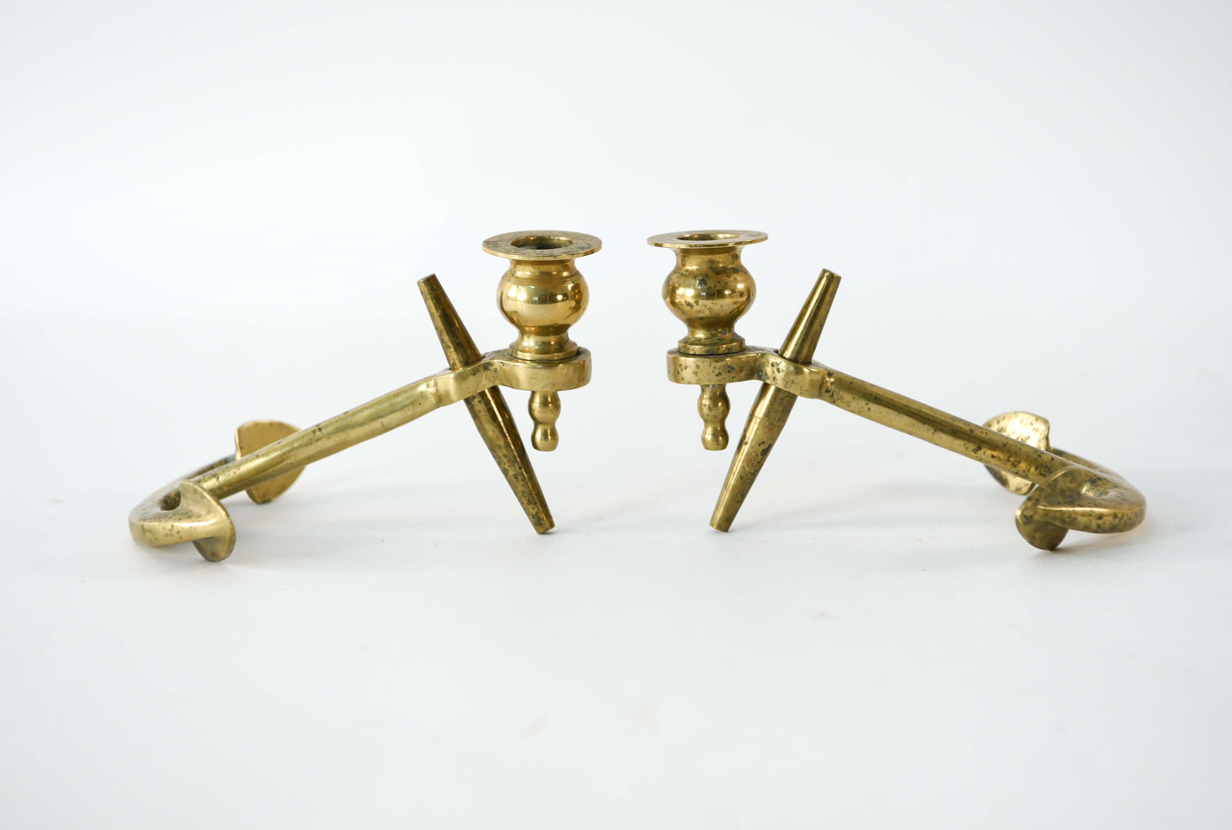 This is a charming pair of brass candlesticks in an anchor form. These would be lovely for a nautical themed interior.