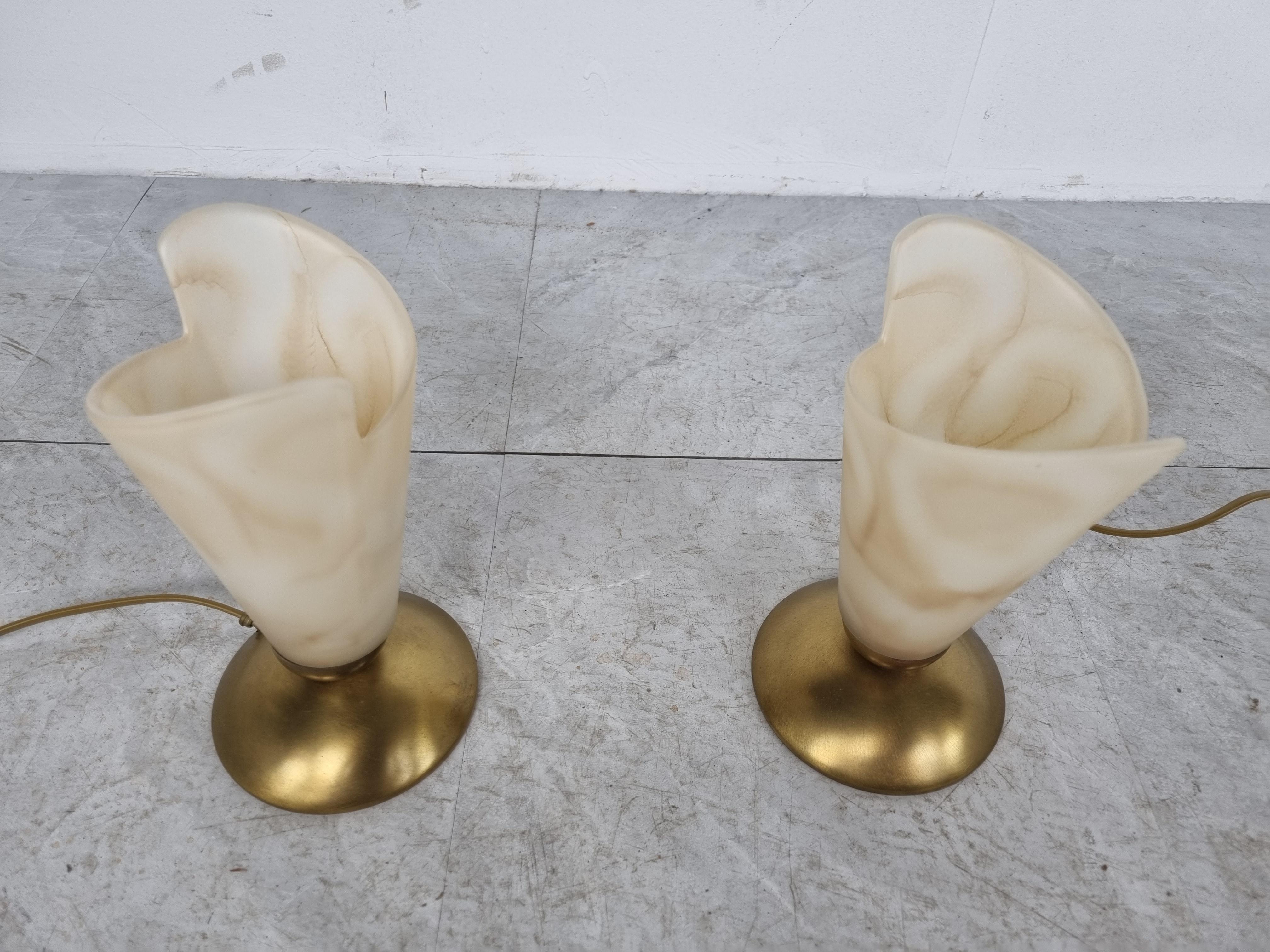 Pair of brass table lamps with alabaster shades.

The lamps emits a beautiful dimmed light.

Tested and ready for use with regular E14 light bulbs.

1980s - Belgium

Dimensions:
Height: 22cm/8.66