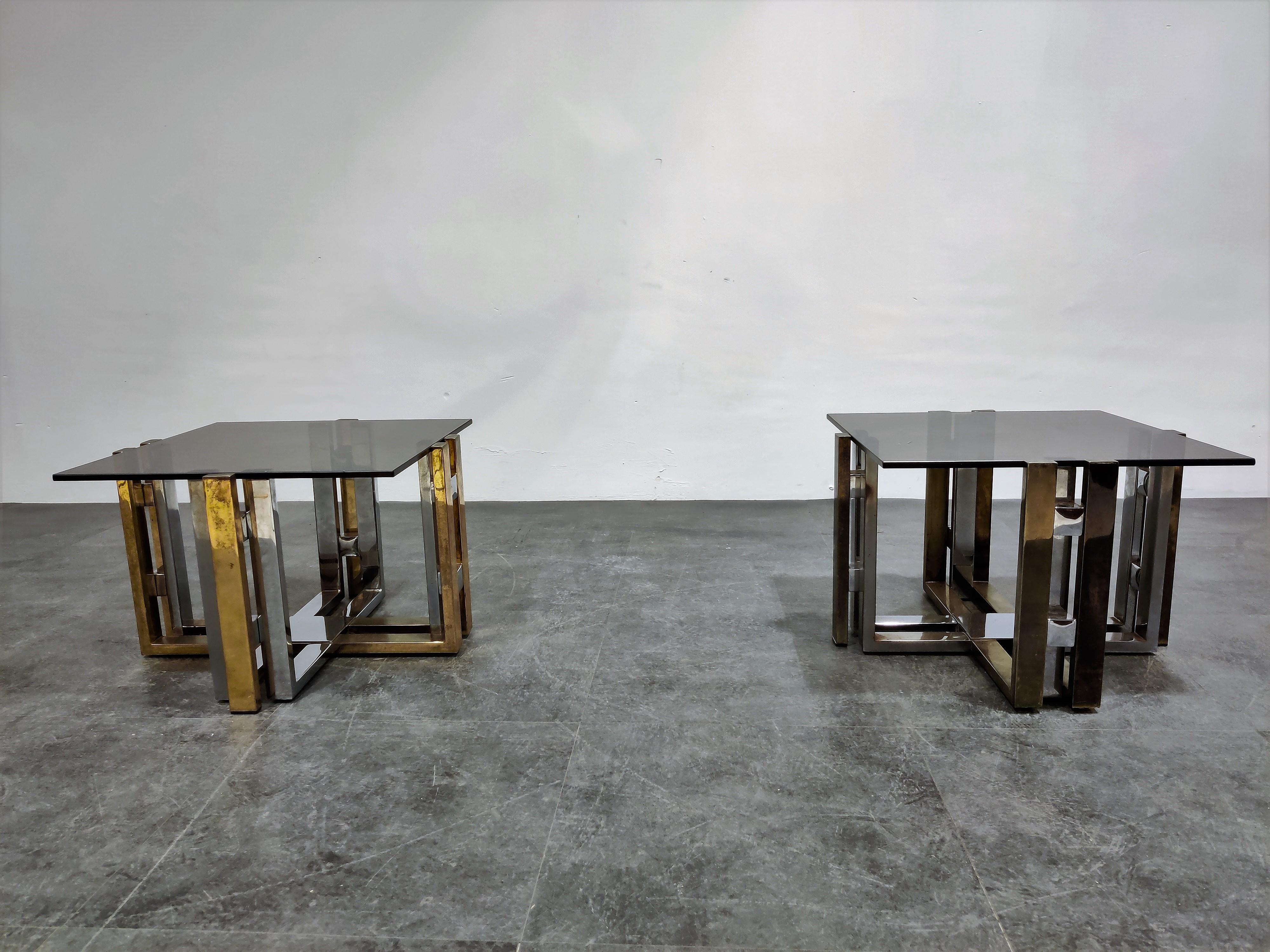 Pair of brass and chrome coffee tables with a smoked glass top in the style of Willy Rizzo or Romeo Rega

Produced by Belgochrom.

Can be used as end table or coffee table or even as bedside tables.

Condition: Patina on the brass/chrome,