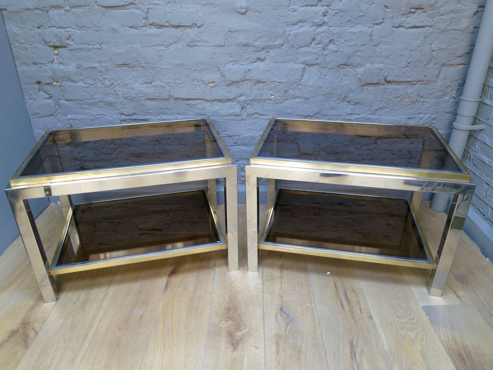 A pair of two tiered end tables in brass and chrome with smoked glass tops. Signed and stamped by Jean Charles.

Paris,

circa 1970s.

Measures: 70cm W x 50cm D x 48cm H.

 