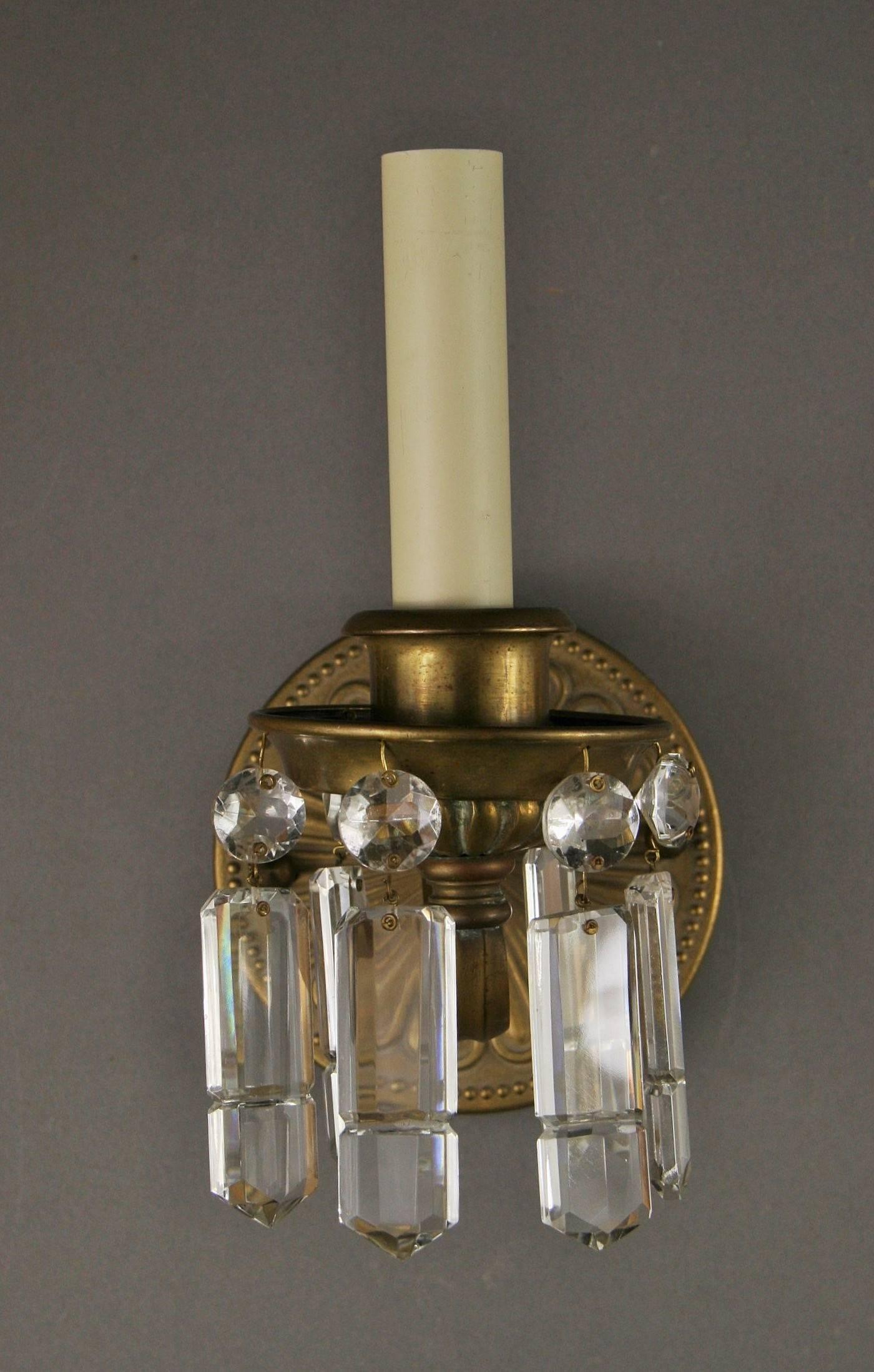 1-4056a pair of brass and crystal one arm sconces. Takes one 60 watt max candelabra base bulb.
 