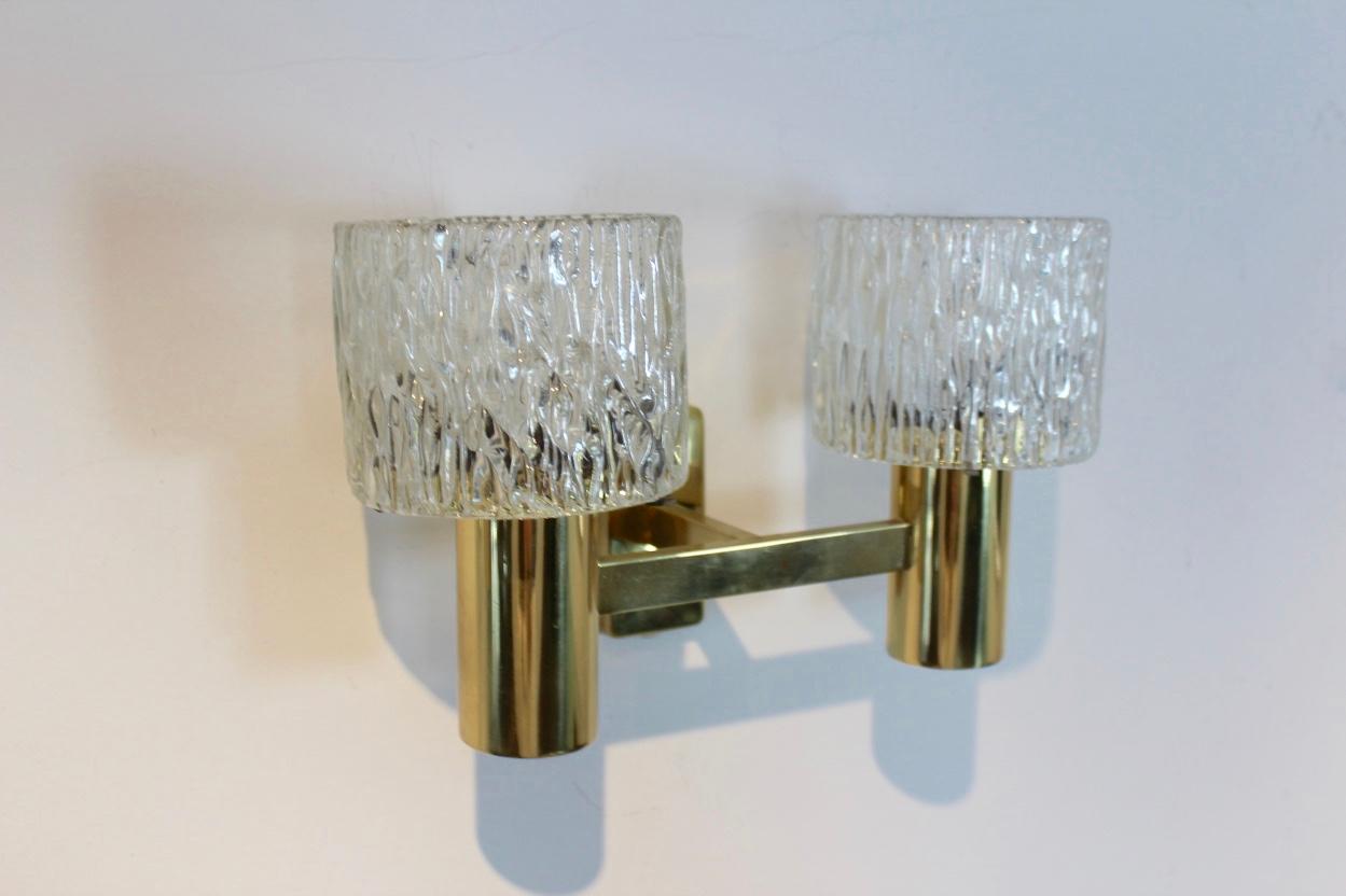 Highly rare and sophisticated pair of brass wall lamps produced in Sweden in the 1970s. Designed by Carl Fagerlund for Orrefors Glasbruk. Each lamp has two Hand Blown Glass shades on a handsome Brass frame with a nice geometrical pattern. In