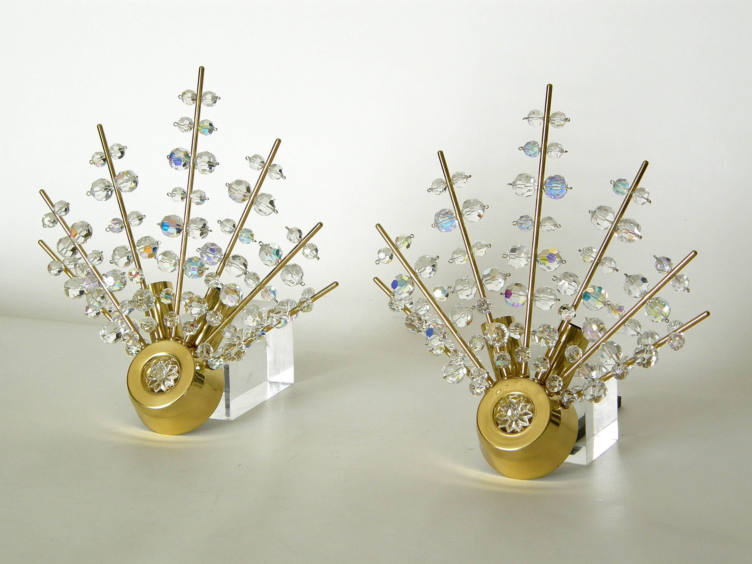 Dramatic and sparkling Sputnik wall sconces attributed to Bakalowits, Austria. The radiating spikes are laden with faceted crystals of different sizes. They are lit from behind, and each sconce has two sockets. 

These sconces were never used by