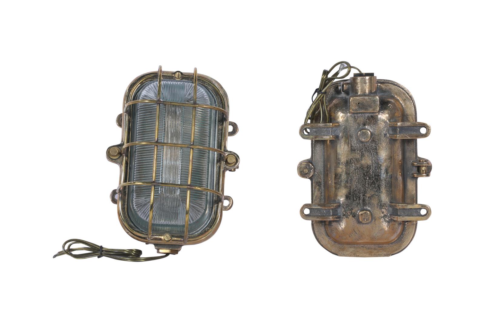 An extraordinary pair of brass and glass Fresnel lens sconces. Unusual larger rectangular size. These were passageway lights used on a ship from the 1970's which has since been decommissioned. Rewired and polished. Takes a standard base bulb. These