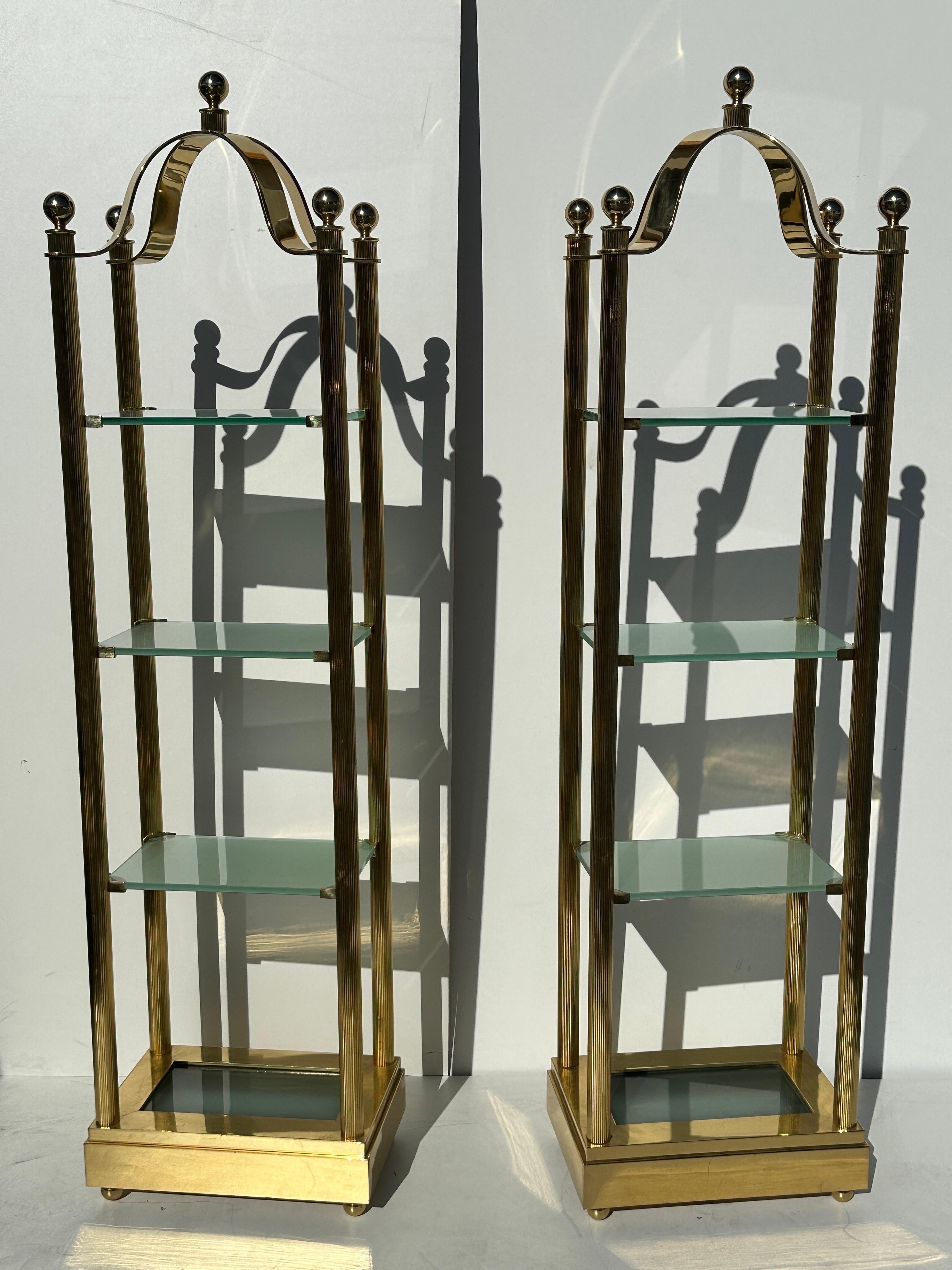 Pair of reeded columnar brass and frosted glass Illuminated etageres.
Clearance between shelves starting from bottom are 15.5