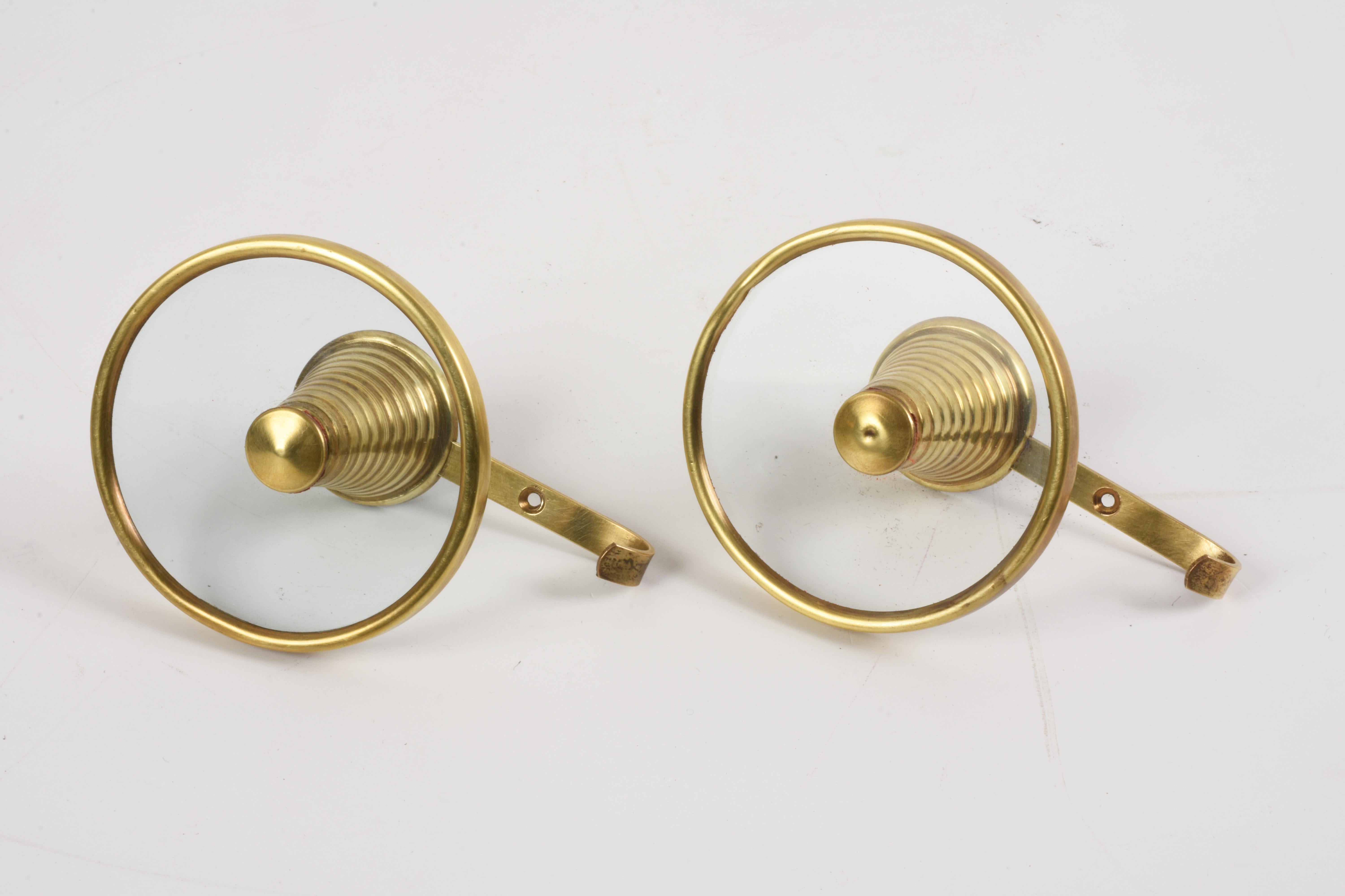 Amazing pair of brass and glass coat hooks.

They are attributed to Fontana Arte and they were produced in Italy during the 1950s.

Glass and brass are integrated with a functional outcome that is unique, making this set perfect for an entrance