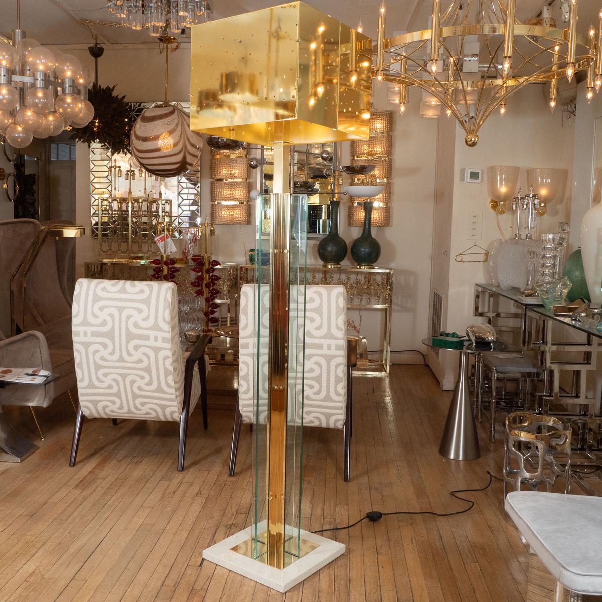 Pair of brass and glass floor lamps with brass decorative shades.