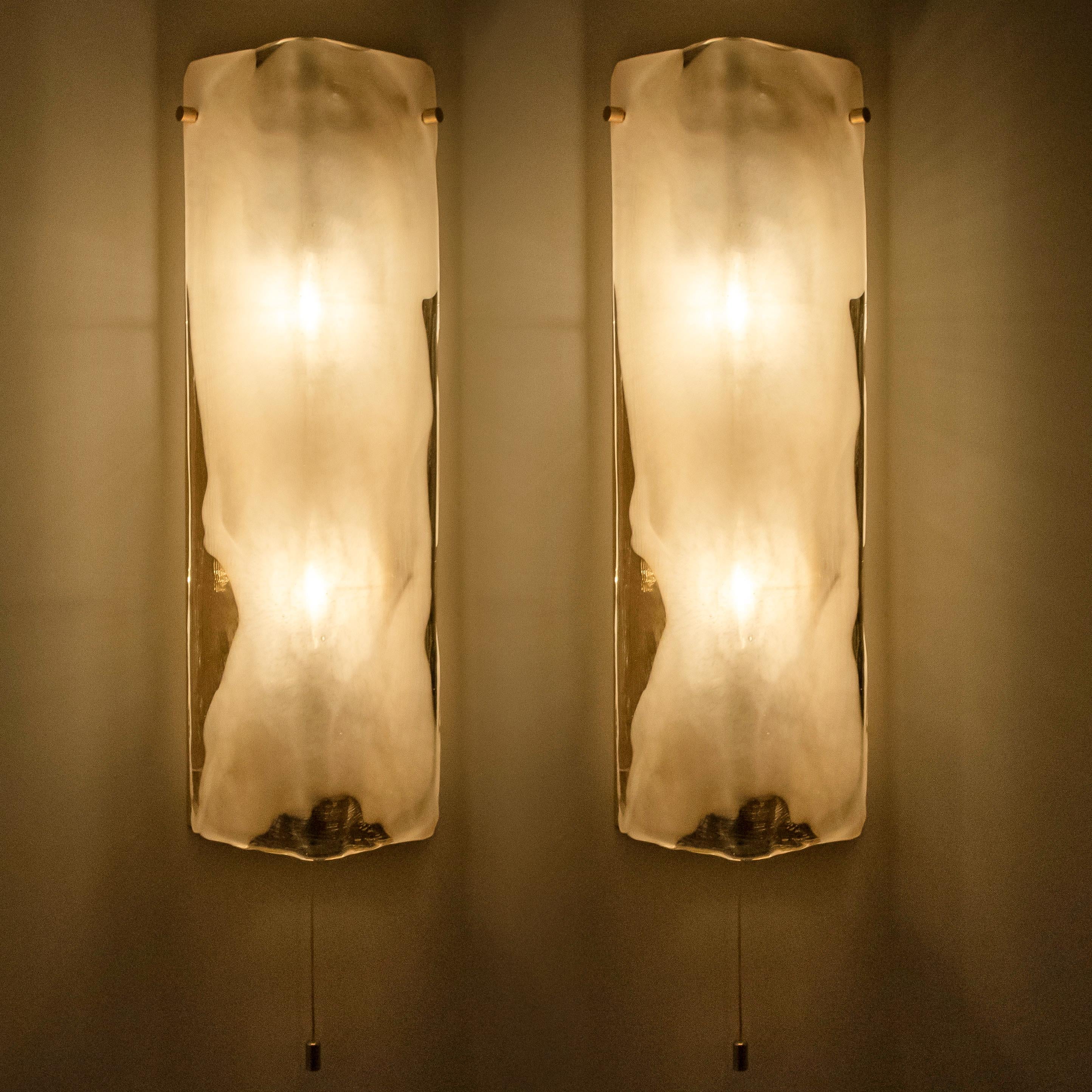 Pair of high end wall sconces made of hand blown clear and white Murano glass on a chrome hardware designed and produced by J.T. Kalmar, Austria in the 1960s. Minimalistic design executed with a taste for excellence in craftsmanship. Statement