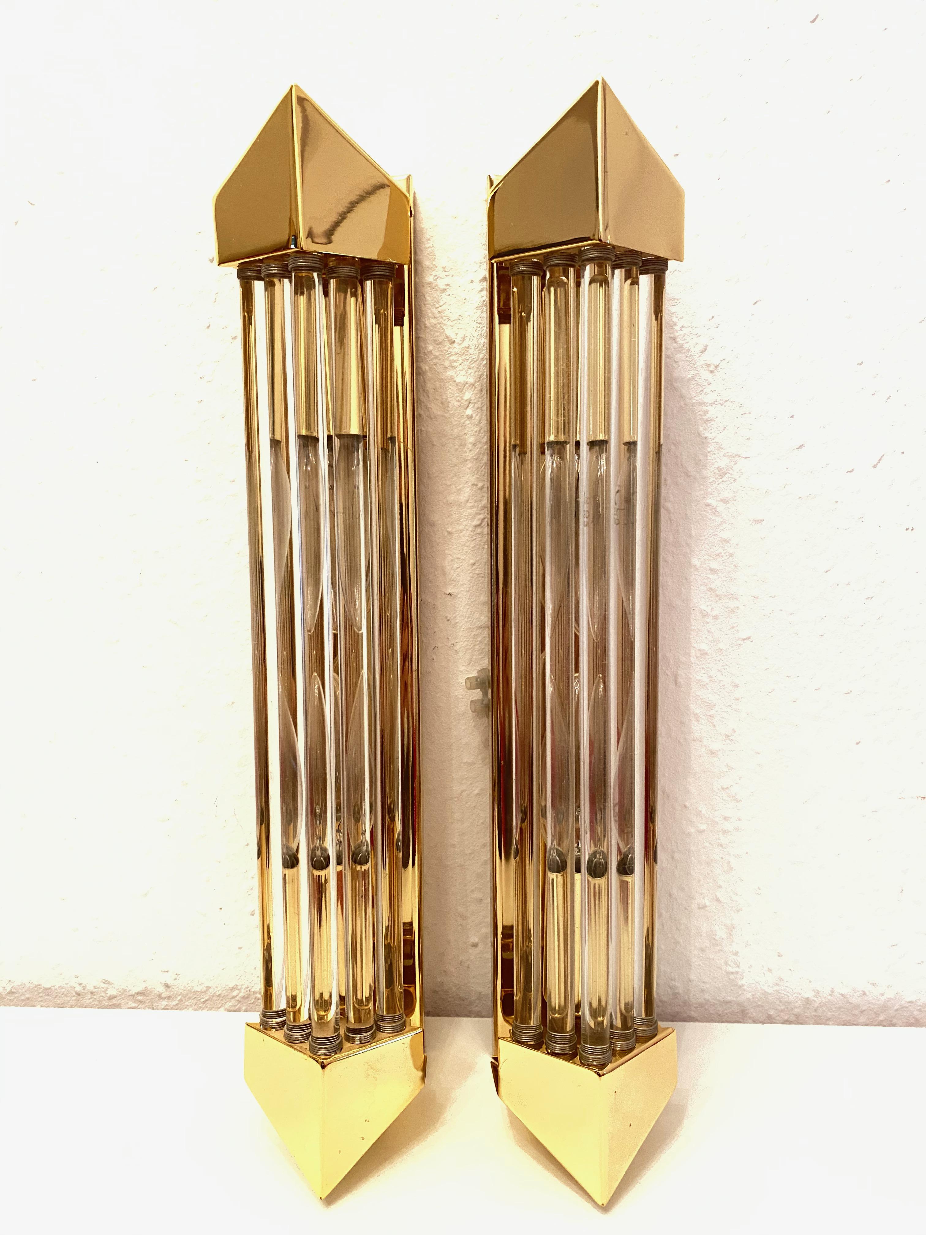 A stunning pair of rod wall sconces made by Honsel Leuchten, Germany. Each with angled brass ends and a single brass wall plate with two sockets and mount make for a beautiful wall light. Easy to mount and fantastic to look at. Each fixture requires