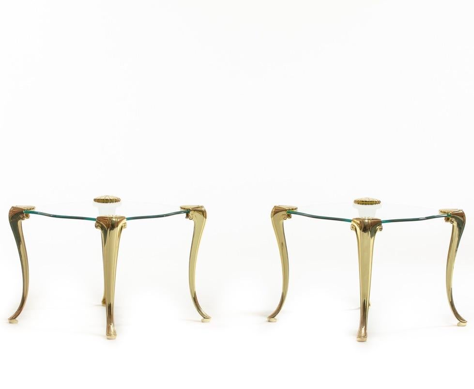 Brass Scroll leg tables with clam shell motif at top holding Serpentine glass tops. Attributed to Chapman. Similar in style to designs by French Design Houses Maison Bagues and P. E. Guerin.