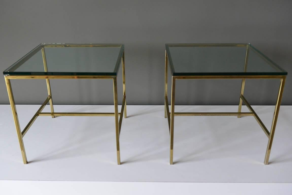 Pair of brass and glass side or end tables, circa 1970. Paul McCobb style, beautiful design. Good condition, some slight patina to brass as shown. Great size and classic design for almost any room. 

Each measures 16