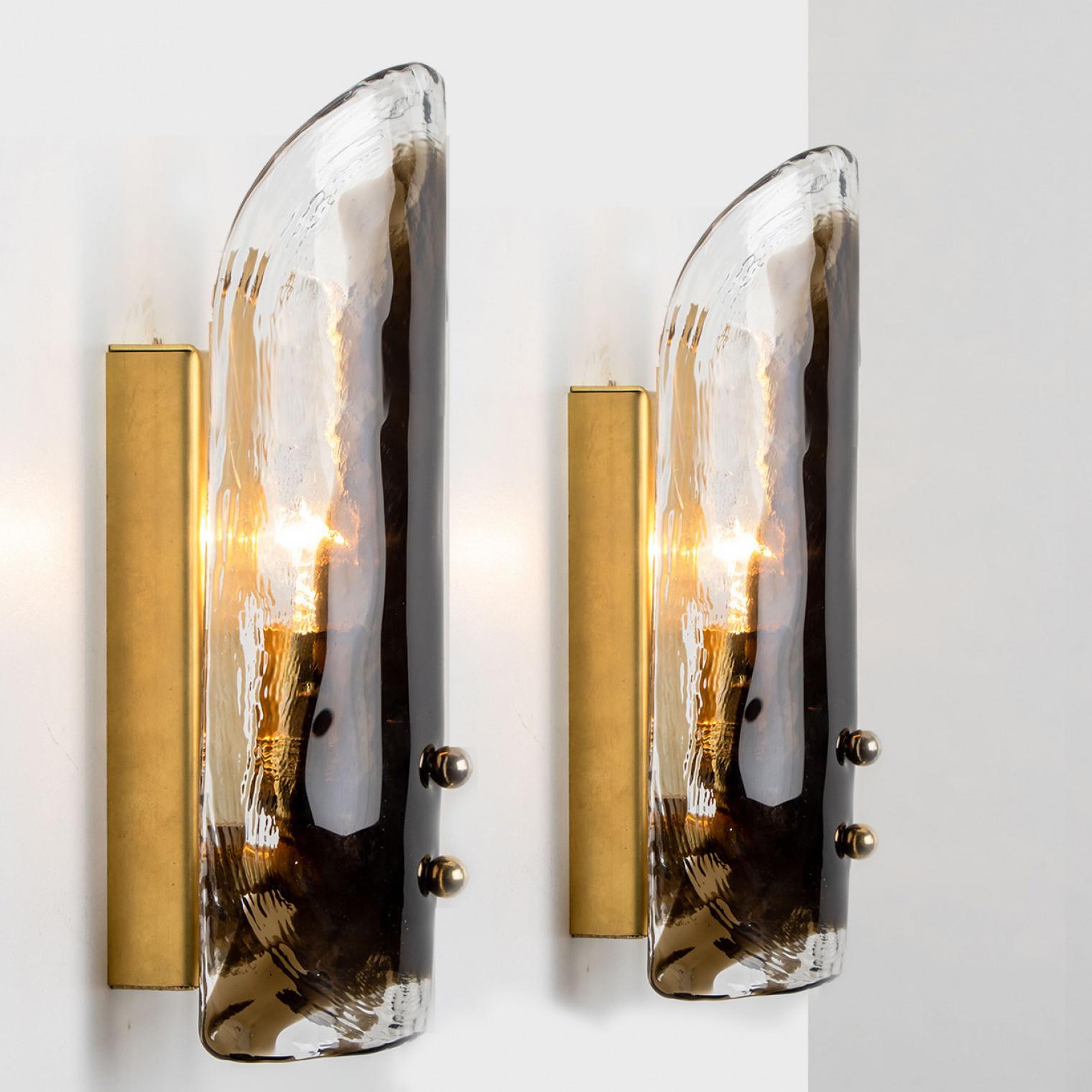 High-end wall sconces made of blown clear and opal Murano glass on a brass hardware. Designed and produced by J.T. Kalmar, Austria in the 1960s. Minimalistic design executed with a taste for excellence in craftsmanship. These are real statement