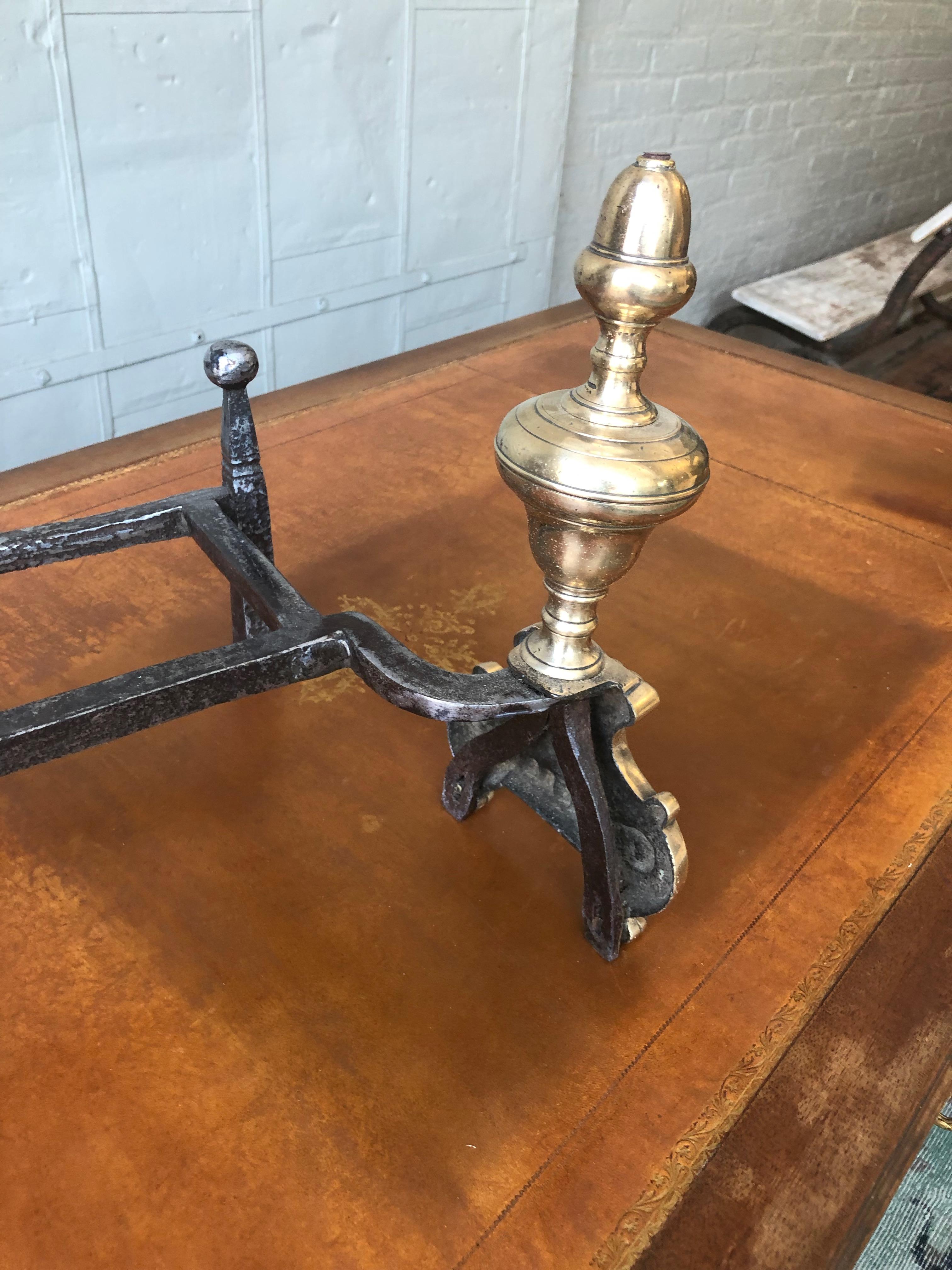 A handsome pair of late 18th-early 19th century French andirons with double iron polished supports and cast brass or bronze decorative fronts. The andirons have recently been polished.

Ref #: D0819-01

Dimensions: 10”H x 11”W  x 14”D

    