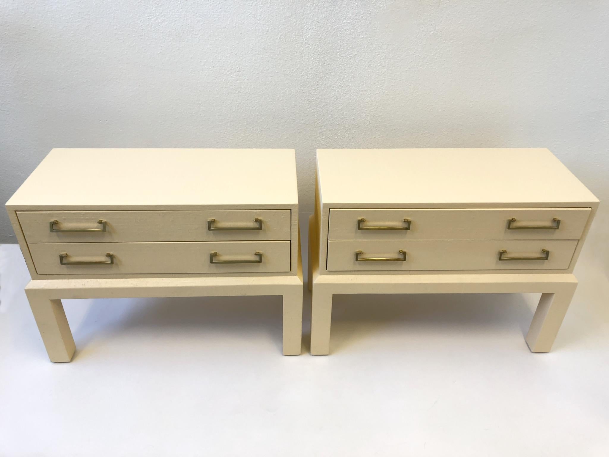 A spectacular 1980s pair of two-drawer nightstands by Steve Chase. The nightstand are constructed of wood covered with grass cloth and lacquer with polish brass pulls.
Dimensions: 25” high 34” wide 16” deep.
 