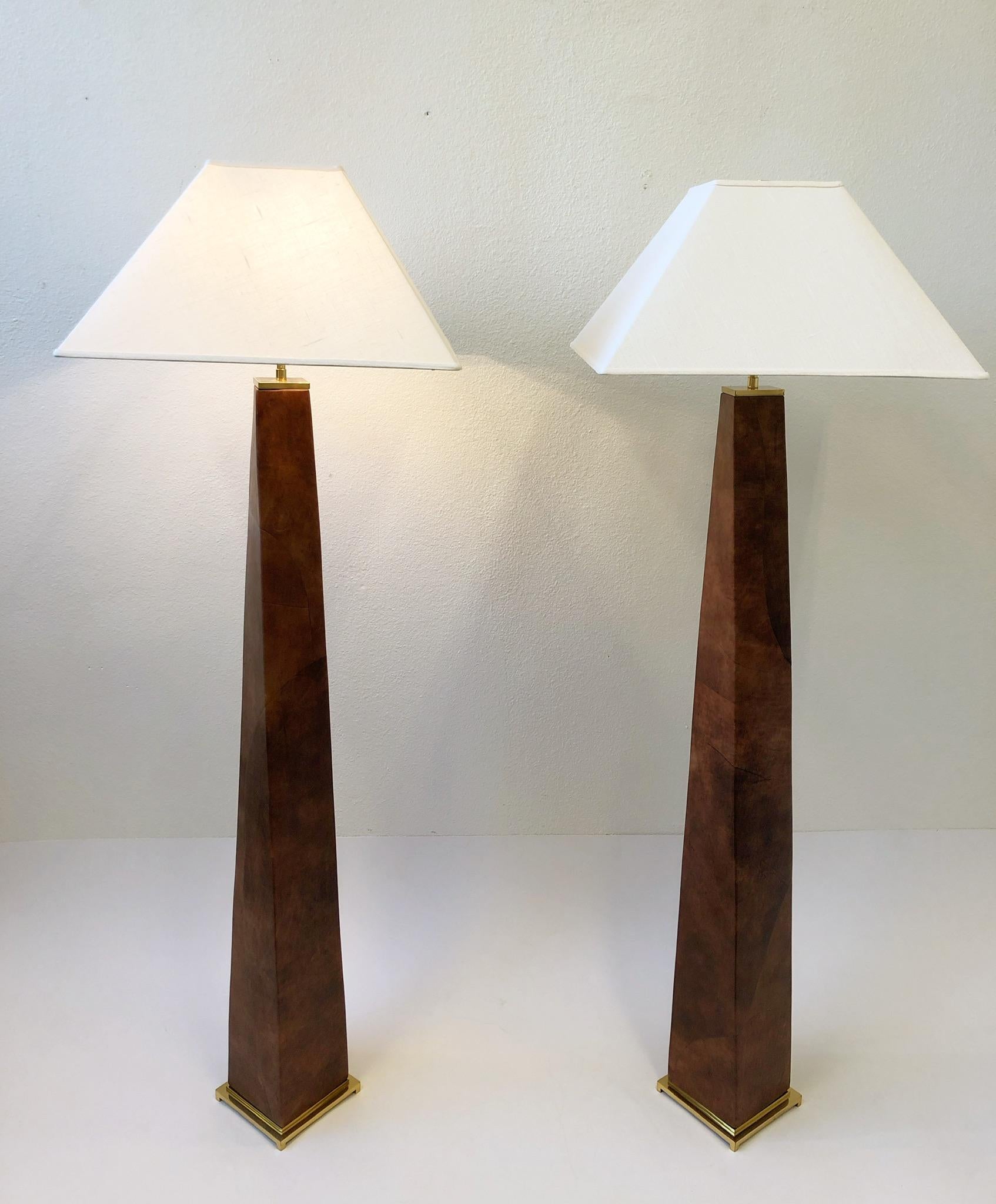 A spectacular pair of 1980’s polish brass and leather J.M.F. floor lamps by renowned American designer Karl Springer. The lamps are constructed of solid brass and wood that’s covered In a patchwork saddle tan leather. New rewired and new vanilla