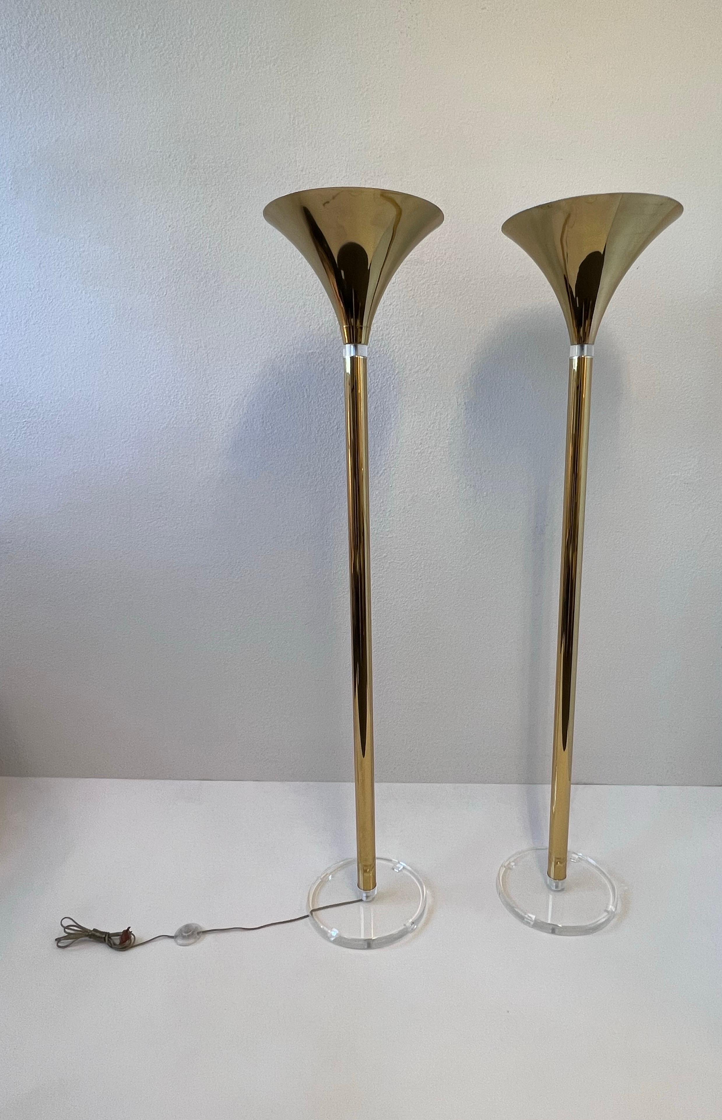 1980’s Glamorous pair of polish brass and clear acrylic floor lamps. 
In original vintage condition, Brass shows some age spots (see detail photos).
They take one 100w max Edison light bulb. 
