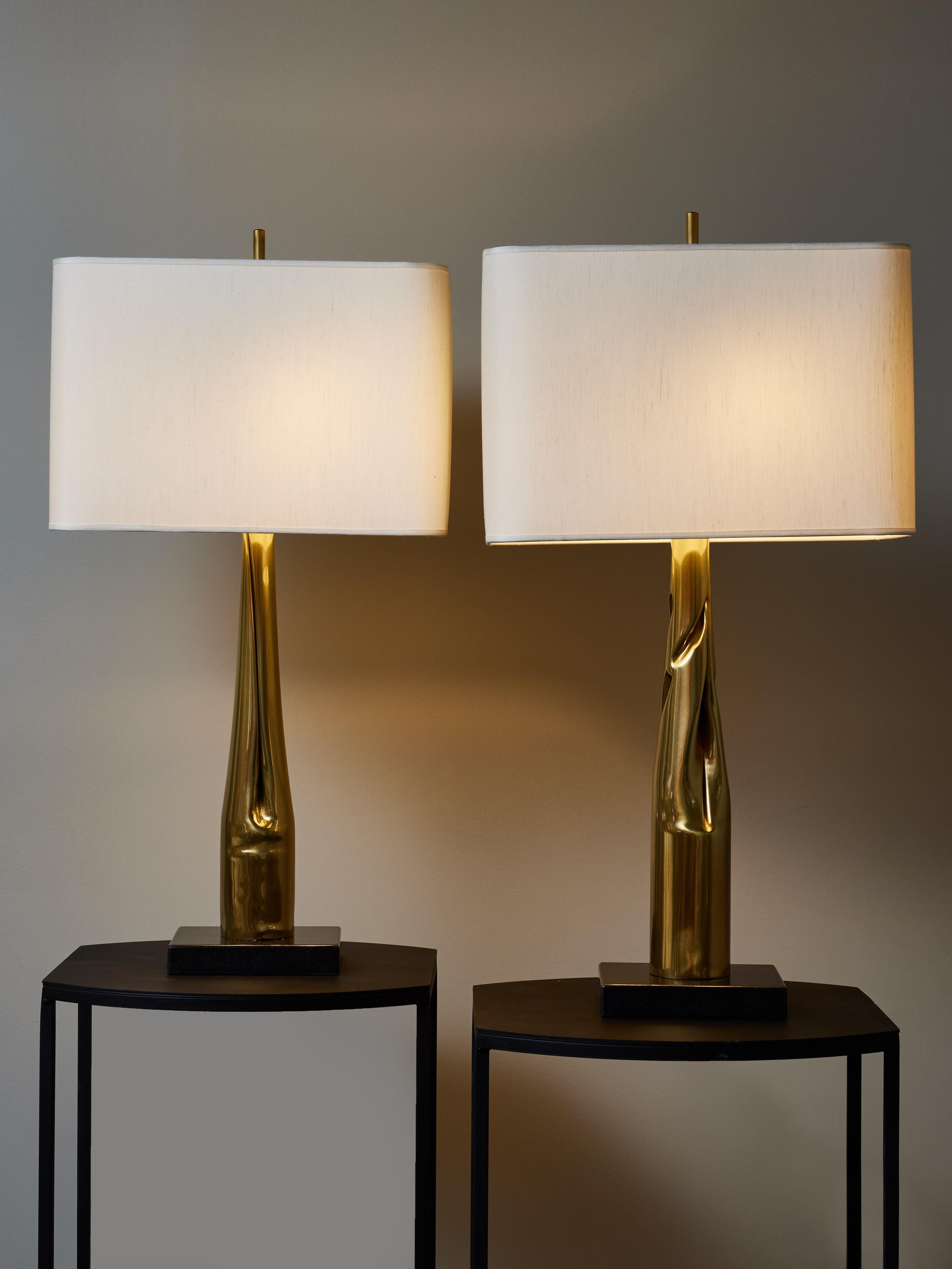Pair of table lamps made of a rectangular black marble base and a long randomly folded brass piece, holding two sources of light.

Made by Esperia exclusively for Glustin Luminaires.