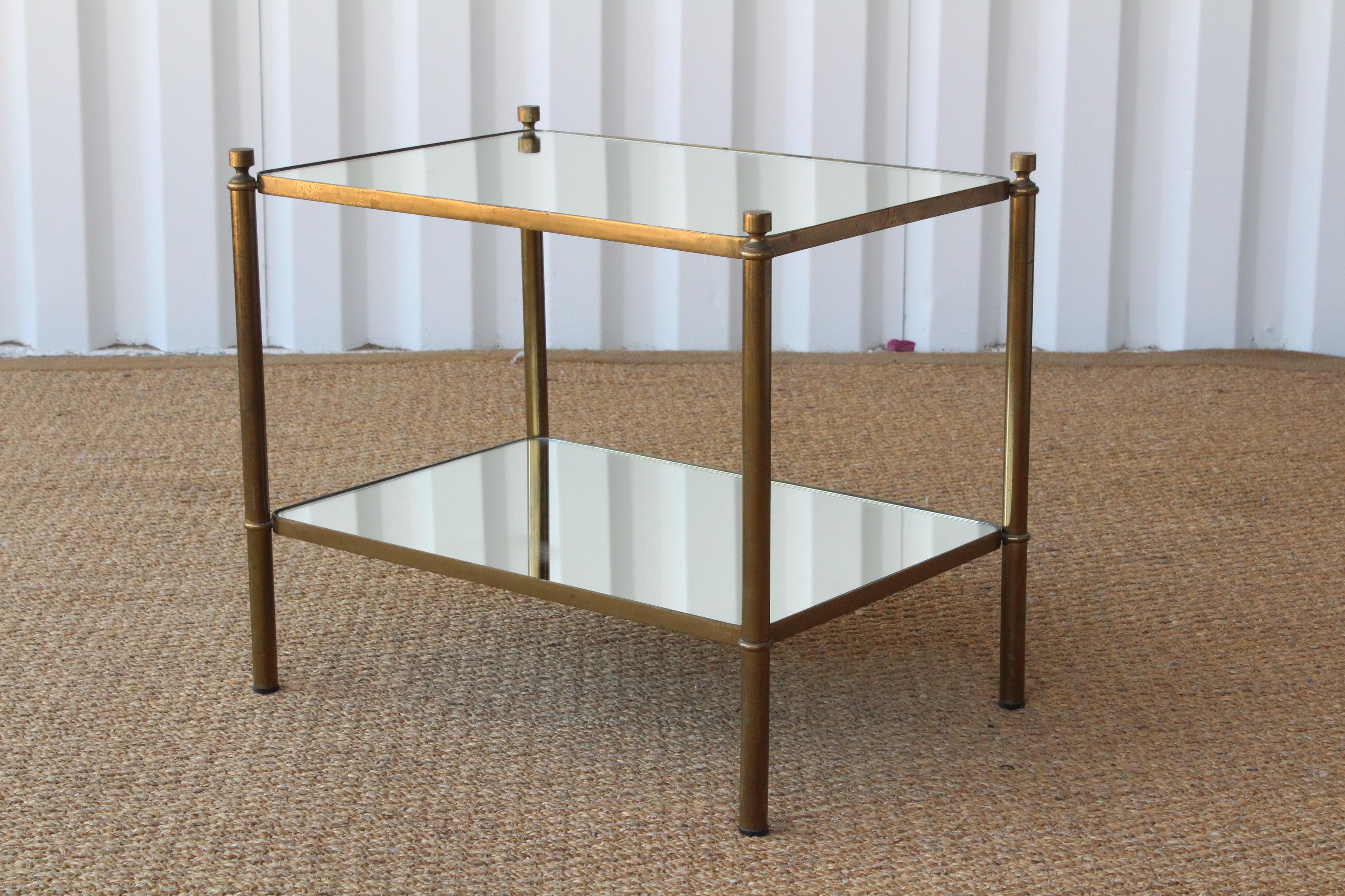 Pair of brass end tables with mirrored shelves, France, 1950s. Brass frames have age appropriate patina. Mirrored tops are new.