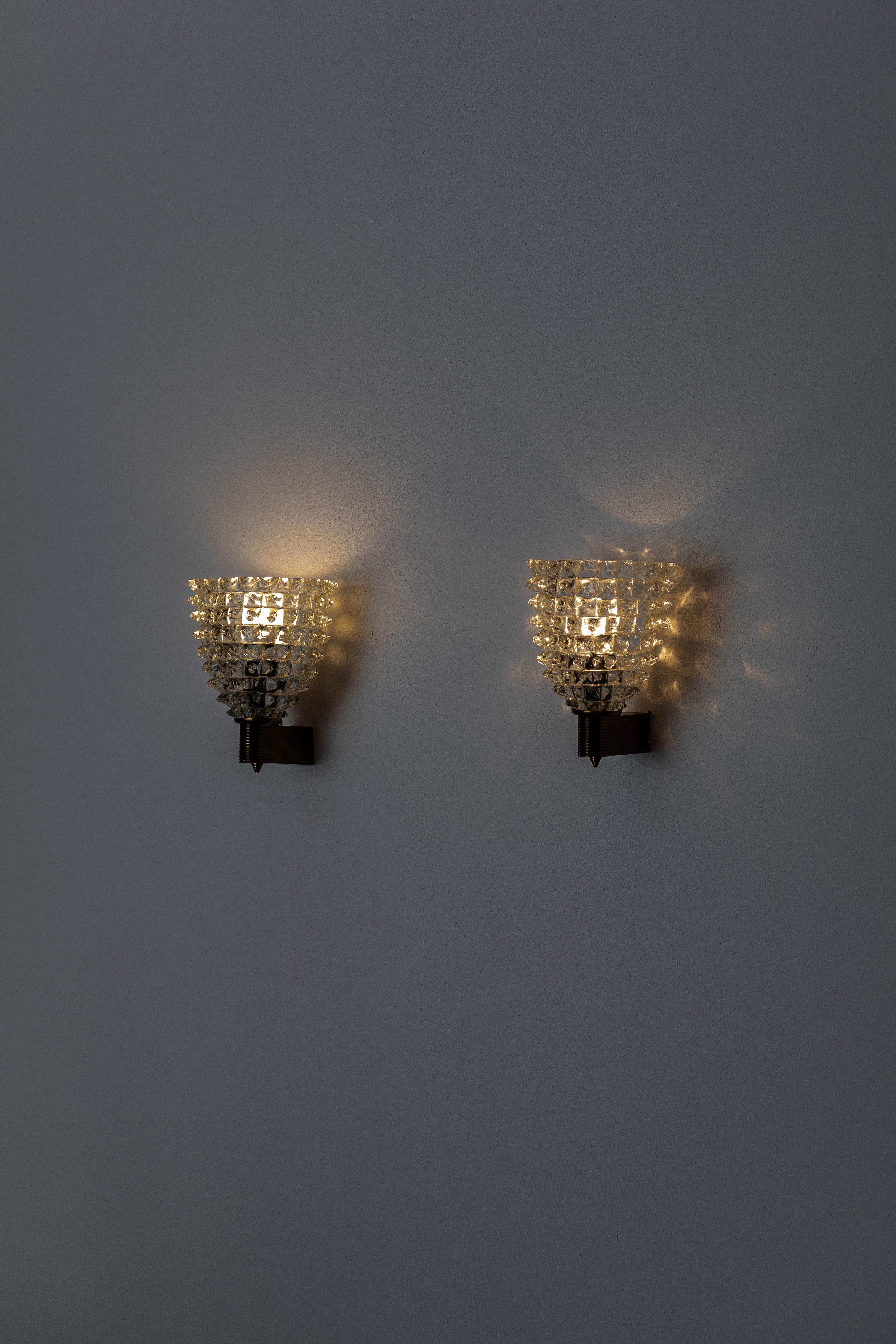 Set of two italian wall light with clear murano glass hand blown to create a beaked textured effect using Rostrato technique, mounted on a golden brass bracket 
Designed by Barovier e Toso, circa 1950s.
  
