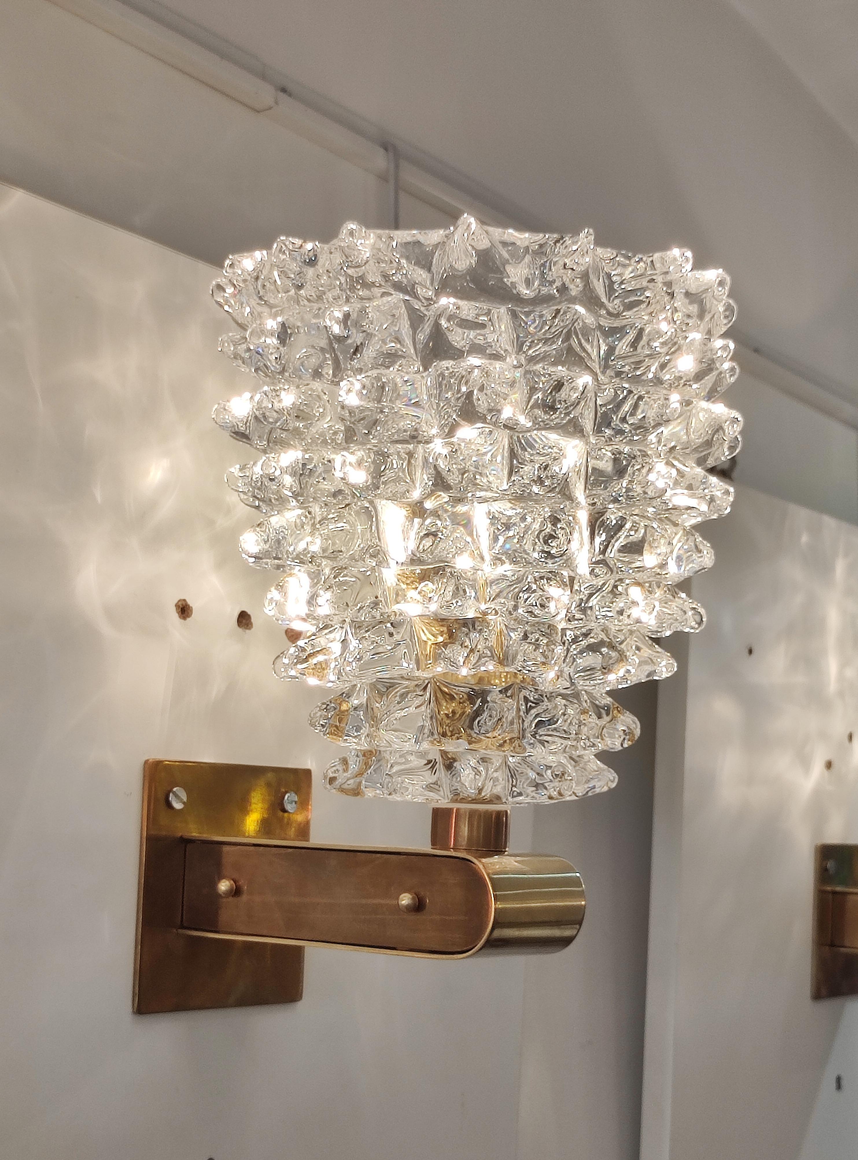 Pair of brass and Murano glass sconces.
