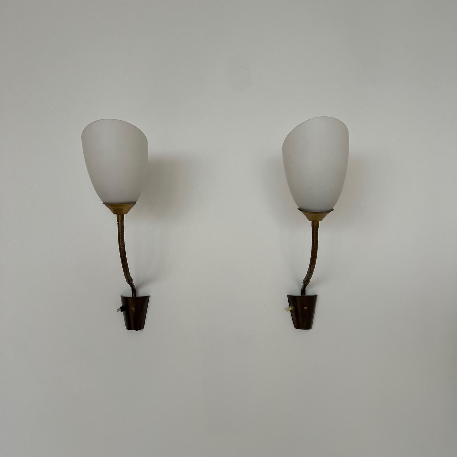 A pair of brass and opaline glass wall lights. 

Adjustable in nature. 

Sweden, c1950s. 

Stamped AJH 37.

Price is for the pair. 

Re-wired and PAT tested. 

Good vintage condition. 

Location: London Gallery. 

Dimensions: 43 H x