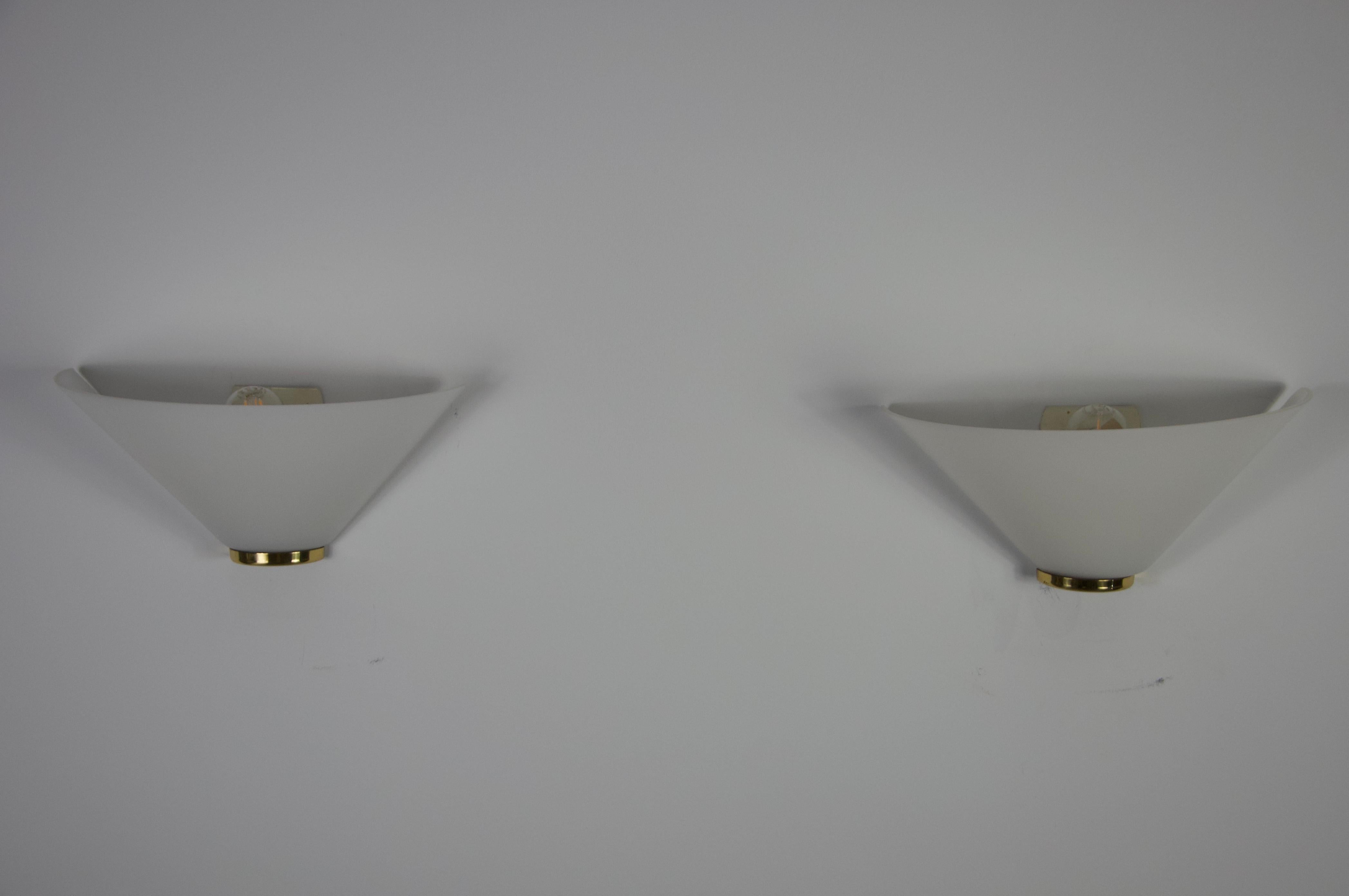 These stylish Limburg wall lamps from the 1960s are outstanding examples of mid-century modern design and German craftsmanship. Their distinctive, funnel-shaped opal glass diffuses the light softly, creating a warm and elegant ambiance in any