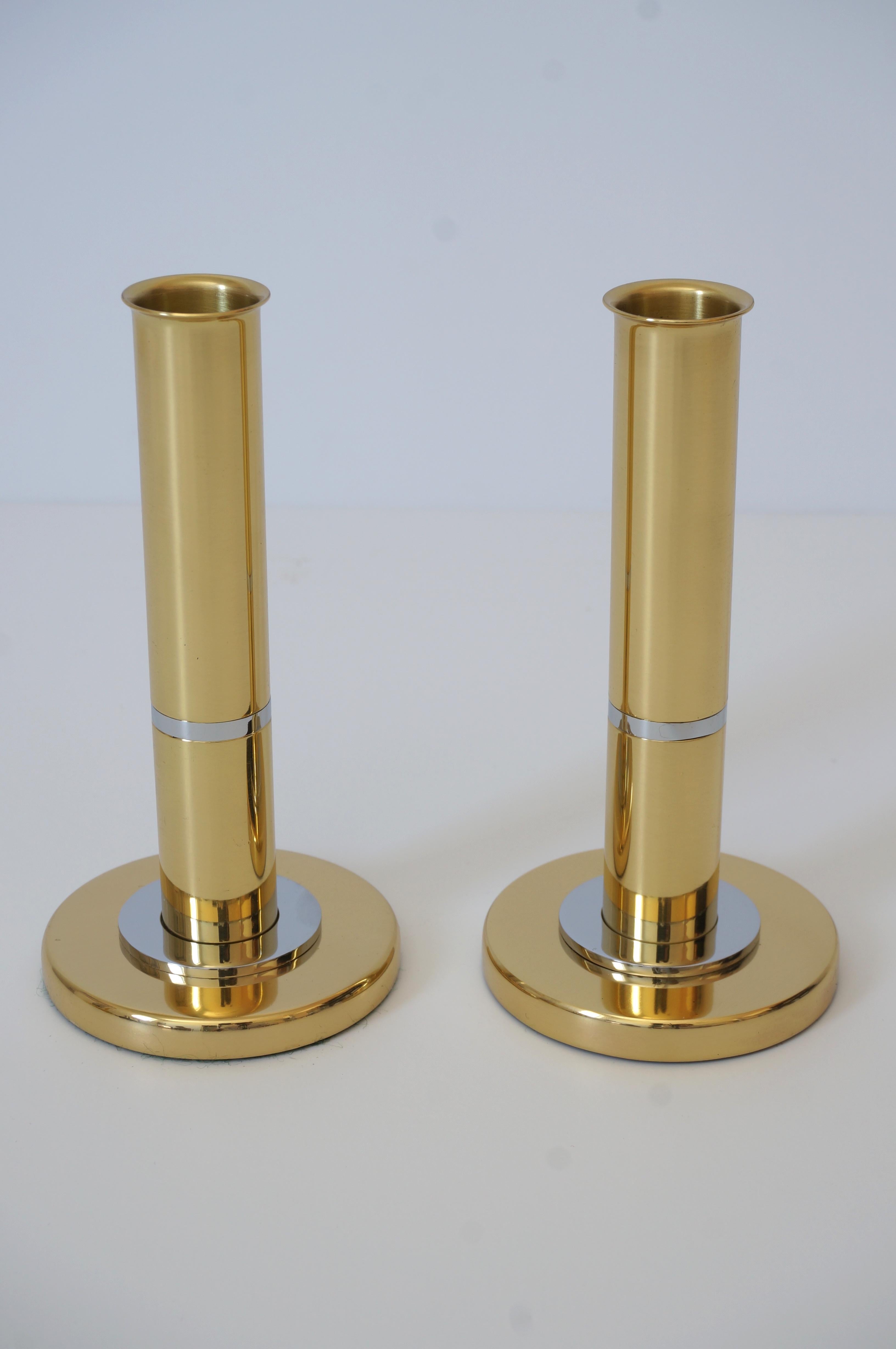 This stylish and chic pair of candlesticks are fabricated in brass and steel, and they are attributed to Karl Springer. The pieces have a weighted bottom and the castings are crisp and fabricated to the highest standards. 

Note: The set has been