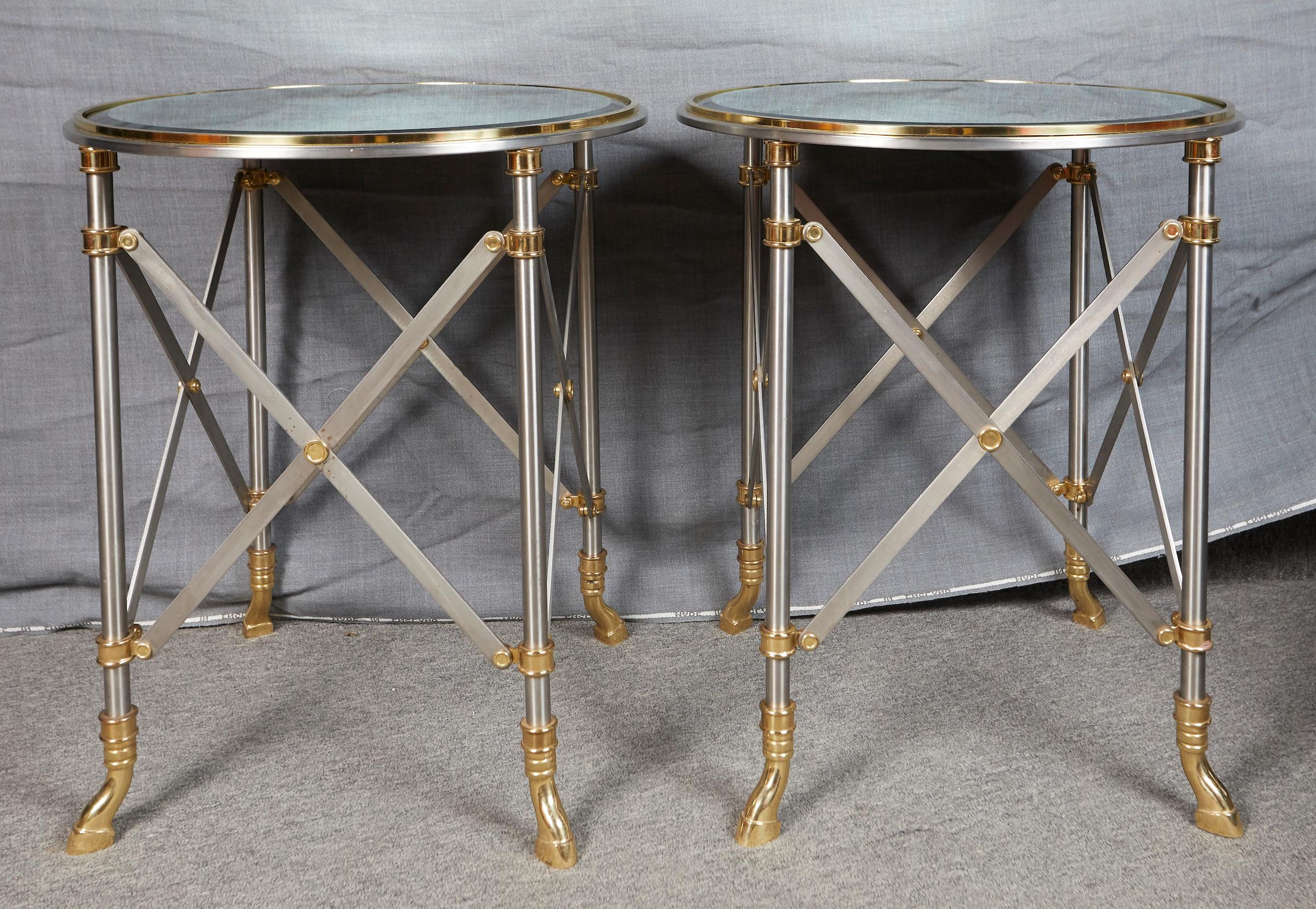 Pair of brass and polished steel circular side tables by Maison Jansen.
Signed under the feet: 